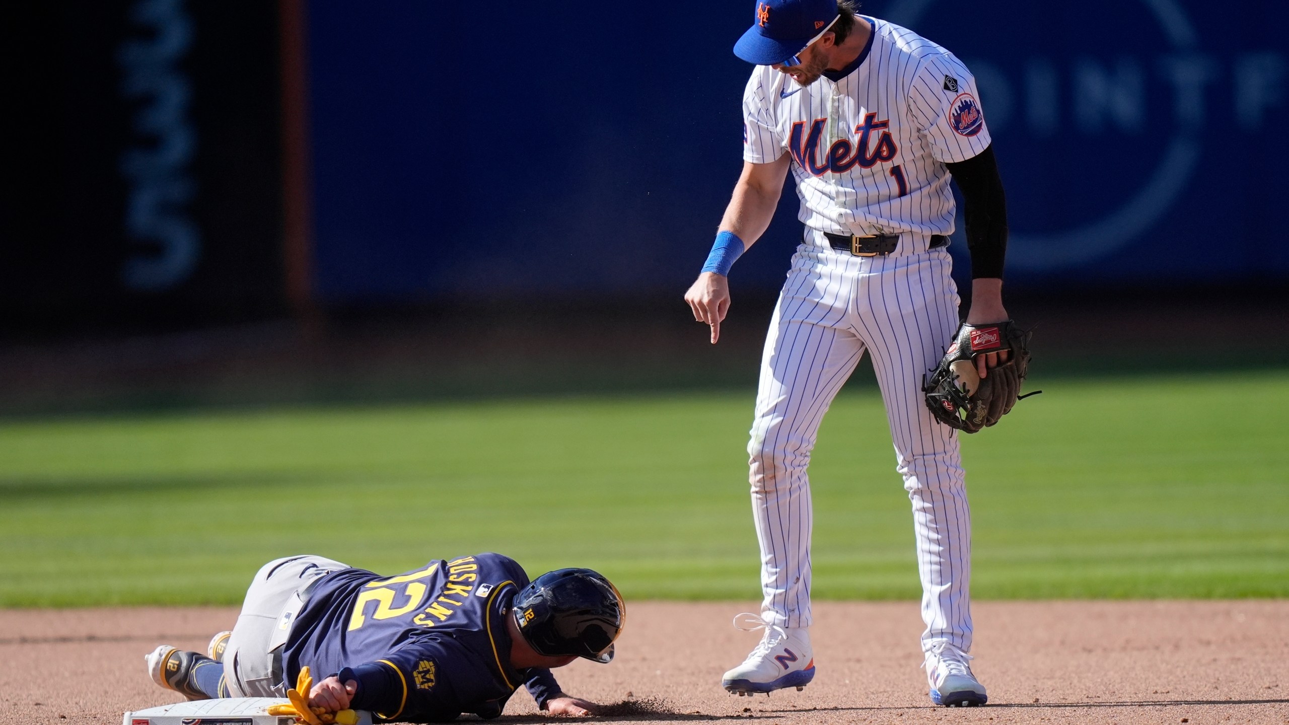 New York Mets' Jeff McNeil (1) exchanges words with Milwaukee Brewers' Rhys Hoskins (12) after Hoskins slid into him during the eighth inning of a baseball game Friday, March 29, 2024, in New York. (AP Photo/Frank Franklin II)