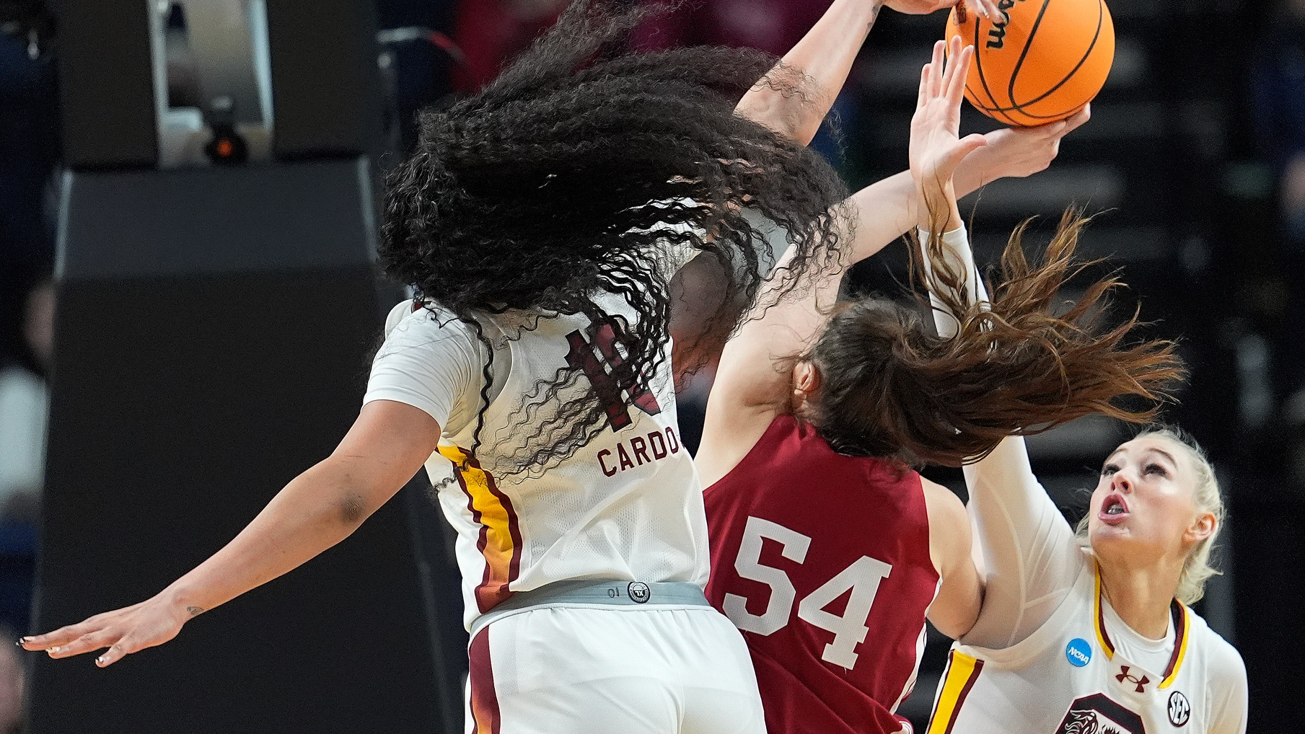 South Carolina center Kamilla Cardoso (10) and forward Chloe Kitts (21) block a shot attempt by Indiana forward Mackenzie Holmes (54) during the first half of a Sweet Sixteen round college basketball game during the NCAA Tournament, Friday, March 29, 2024, in Albany, N.Y. (AP Photo/Mary Altaffer)