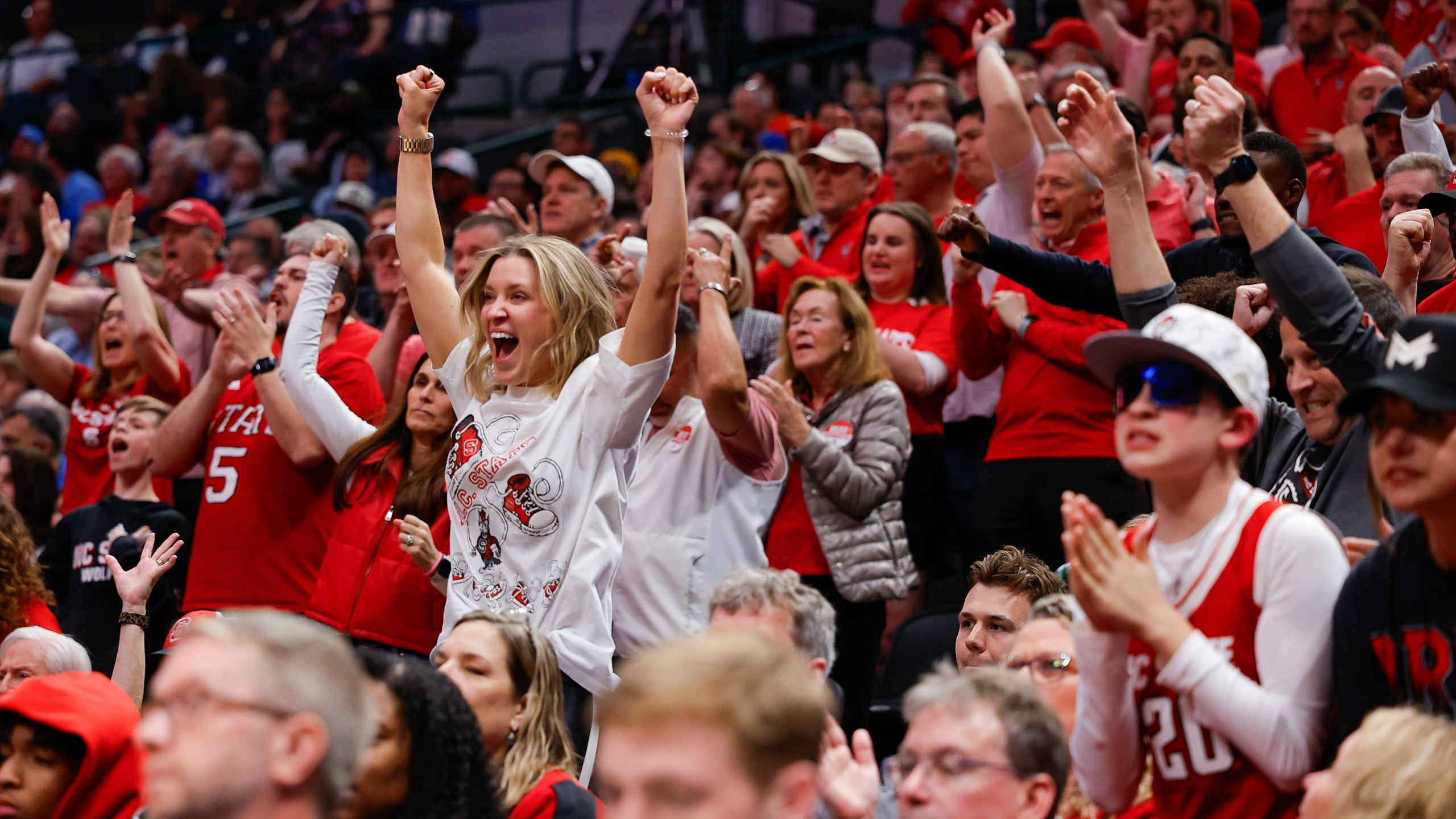 North Carolina State fans react during the second half of a Sweet 16 college basketball game against Marquette in the NCAA Tournament in Dallas, Friday, March 29, 2024. (AP Photo/Brandon Wade)