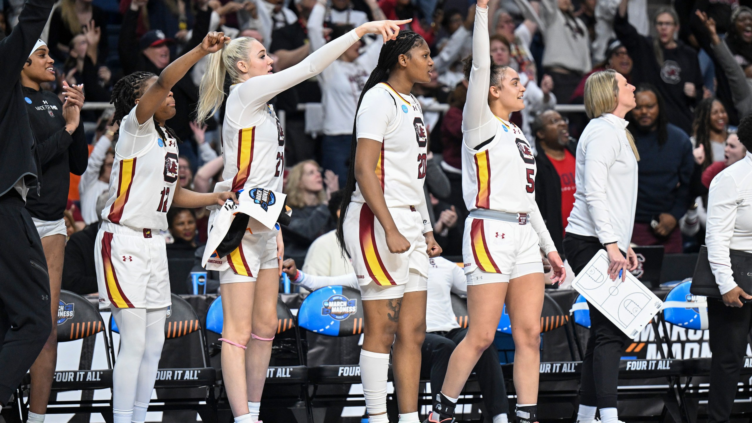 South Carolina guard MiLaysia Fulwiley (12), forward Chloe Kitts (21), forward Sania Feagin (20) and guard Tessa Johnson (5) react during the second half of a Sweet Sixteen round college basketball game during the NCAA Tournament, Friday, March 29, 2024, in Albany, N.Y. (AP Photo/Hans Pennink)