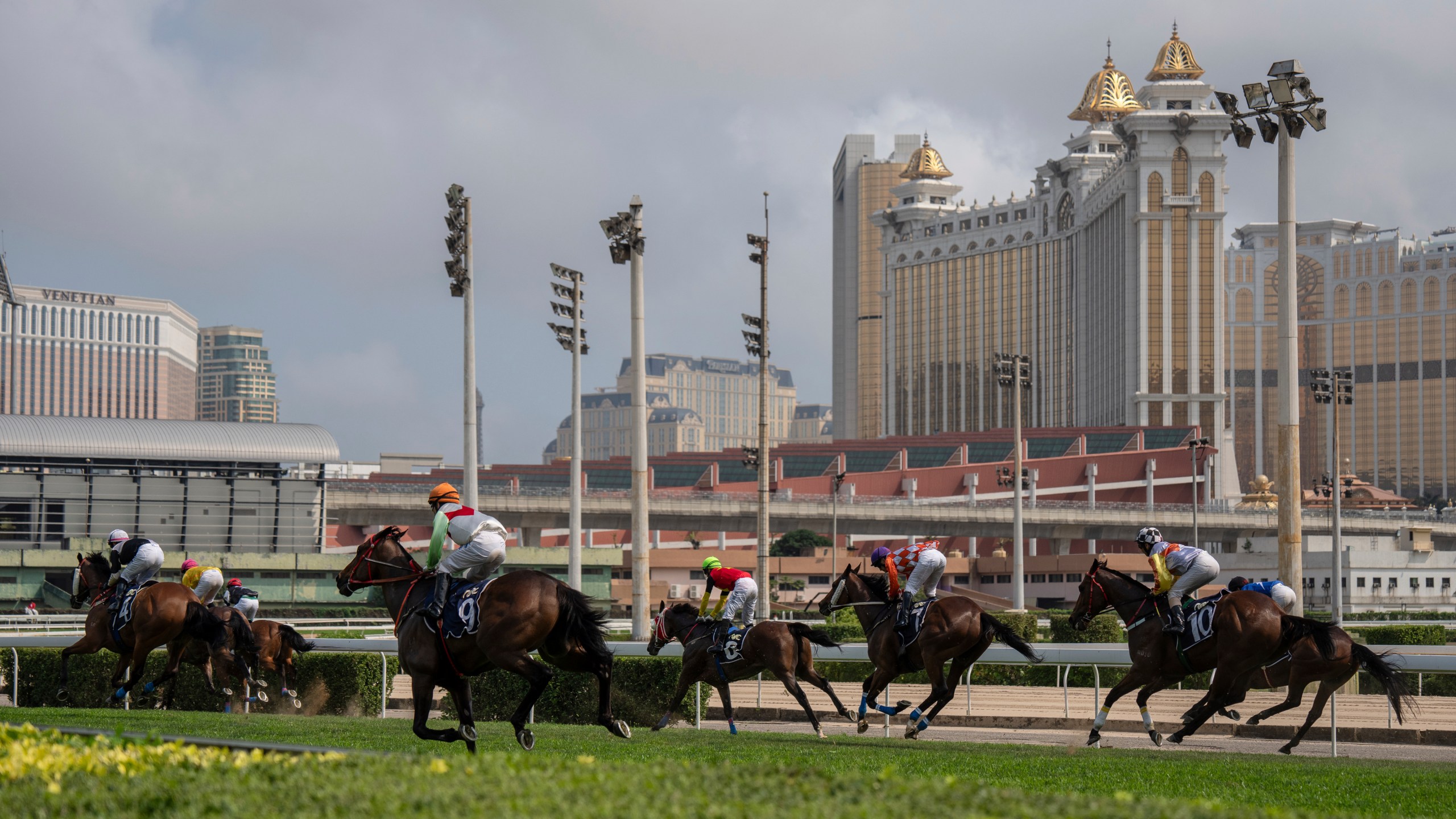 Jockeys compete in last Macao races at the Macao Jockey Club in Macao, Saturday, March 30, 2024. After more than 40 years, Macao’s horse racing track hosted its final races on Saturday, bringing an end to the sport in the city famous for its massive casinos. (AP Photo/Louise Delmotte)