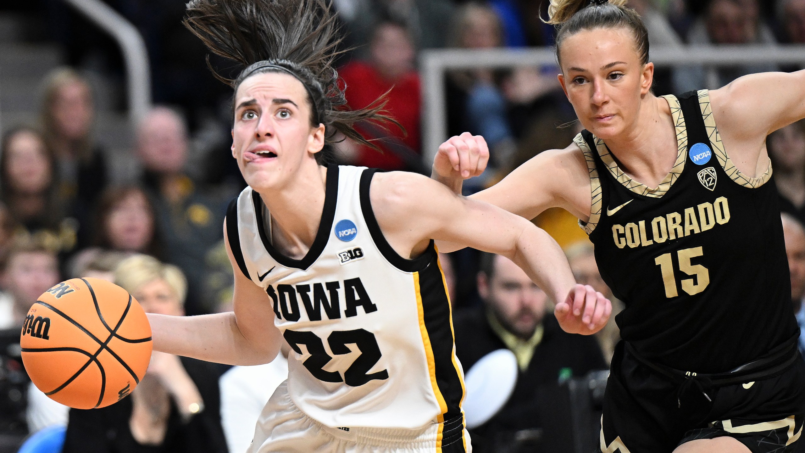 Iowa guard Caitlin Clark (22) drives to the basket against Colorado guard Kindyll Wetta (15) during the fourth quarter of a Sweet Sixteen round college basketball game during the NCAA Tournament, Saturday, March 30, 2024, in Albany, N.Y. (AP Photo/Hans Pennink)