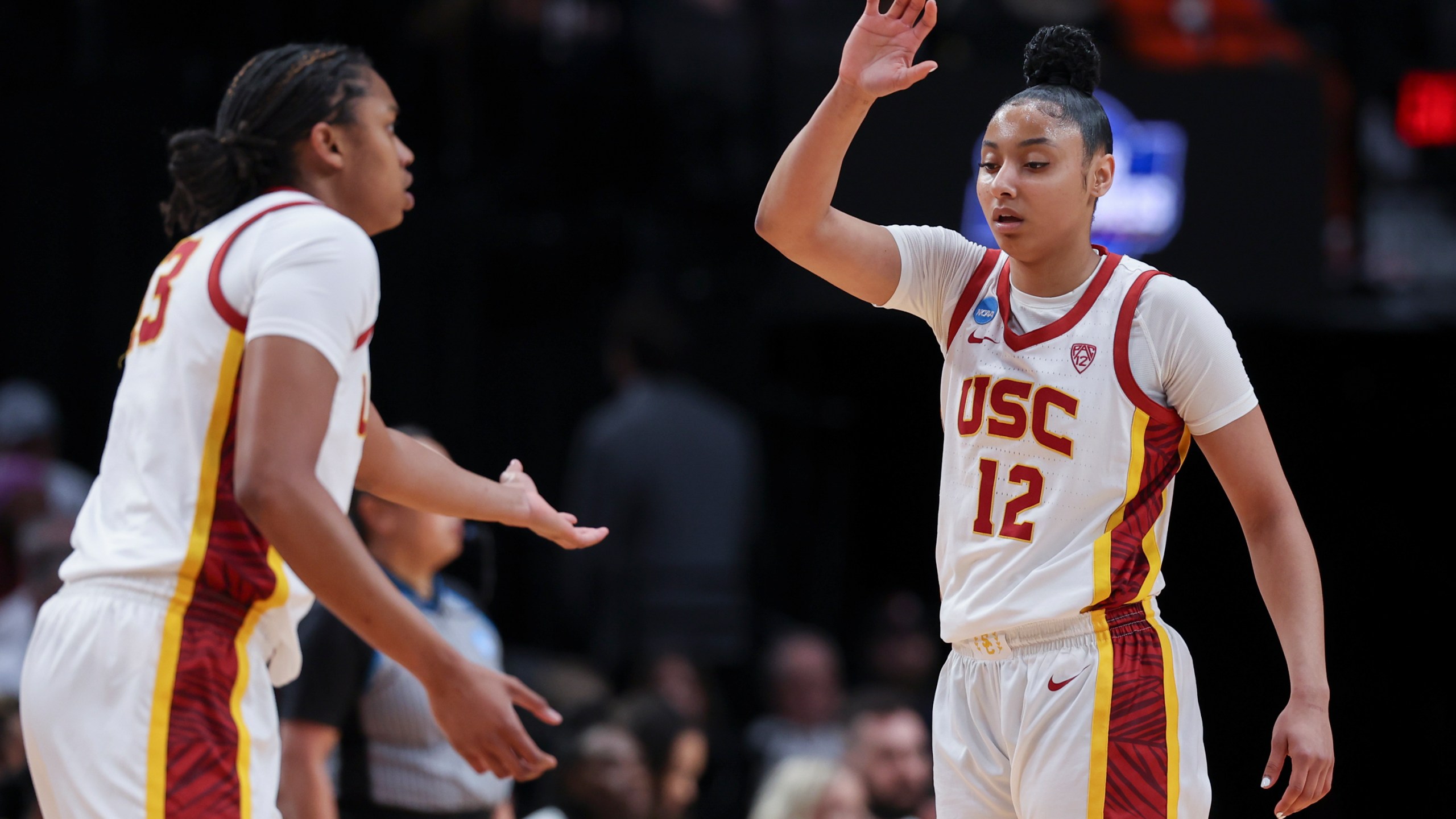 Southern California center Rayah Marshall, left, and guard JuJu Watkins (12) greet each other on the court during the first half of a Sweet 16 college basketball game against Baylor in the women's NCAA Tournament, Saturday, March 30, 2024, in Portland, Ore. (AP Photo/Howard Lao)