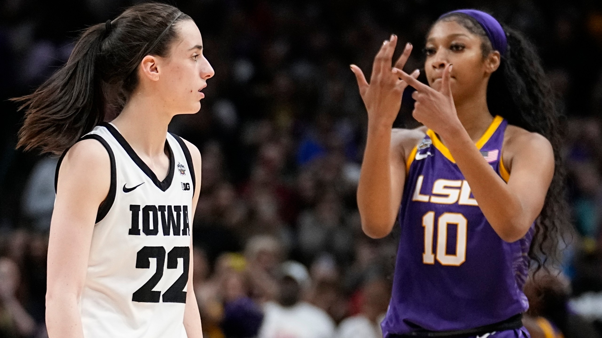 FILE -LSU's Angel Reese reacts in front of Iowa's Caitlin Clark during the second half of the NCAA Women's Final Four championship basketball game April 2, 2023, in Dallas. Iowa and LSU are getting ready to meet again in a rematch of the 2023 national championship game on Monday, April 1, 2024. (AP Photo/Tony Gutierrez, File)