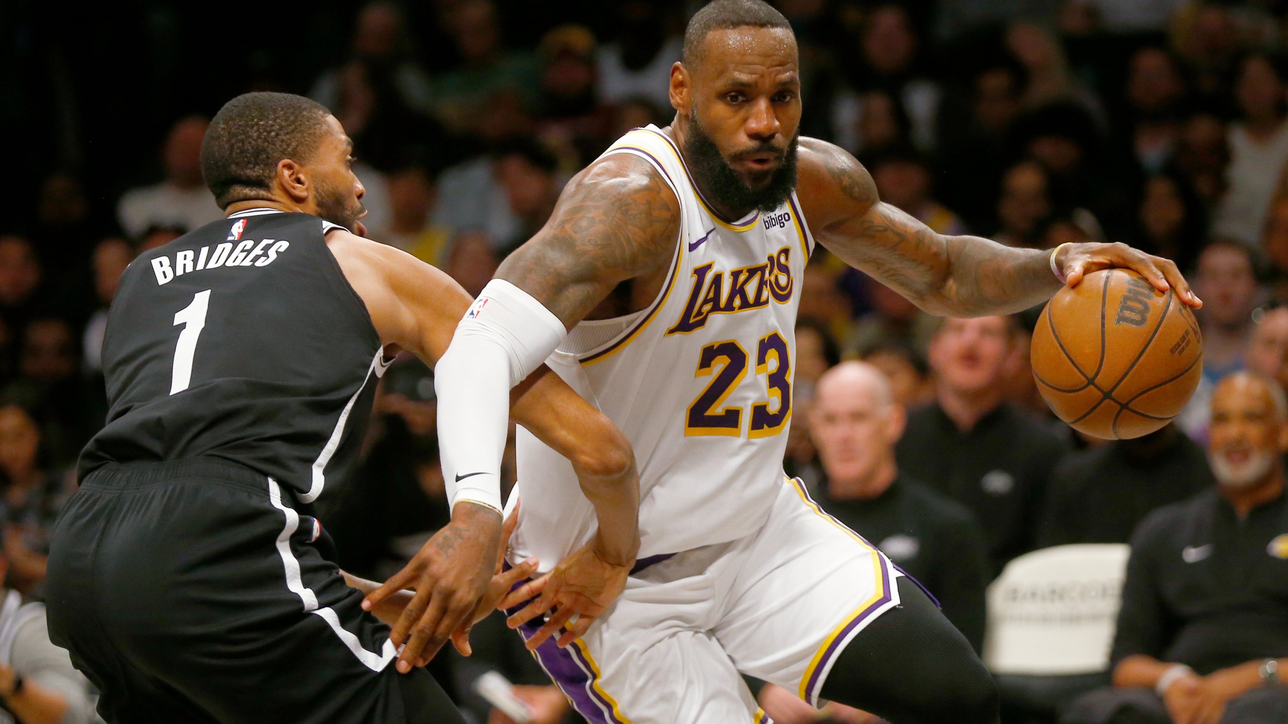 Los Angeles Lakers forward LeBron James (23) drives around Brooklyn Nets guard Mikal Bridges (1) during the first half of an NBA basketball game Sunday, March 31, 2024, in New York. (AP Photo/John Munson)