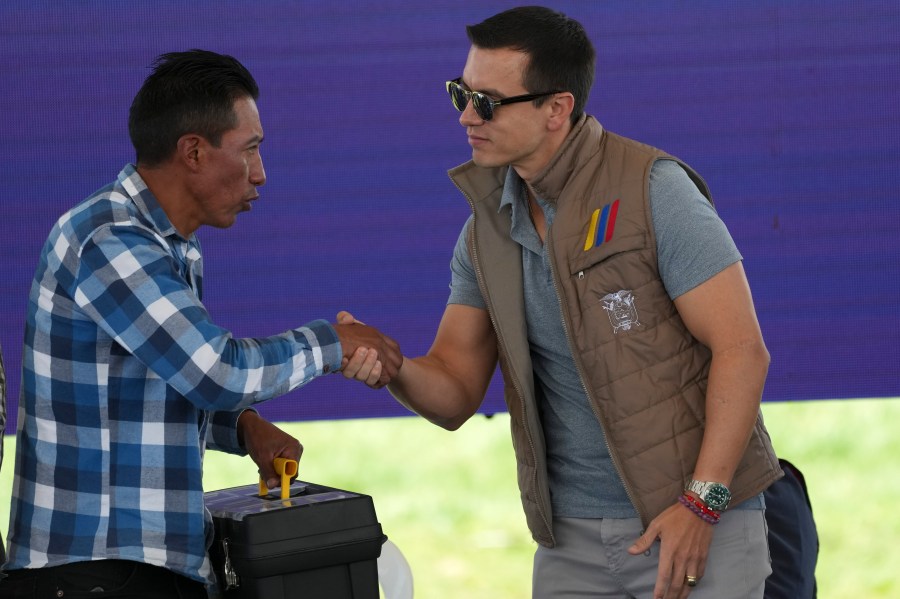 Ecuador's President Daniel Noboa shakes hands with a farmer during his visit to Poalo, Ecuador, Thursday, March 21, 2024, where he met with dairy farmers and handed out 400 land titles. (AP Photo/Dolores Ochoa)