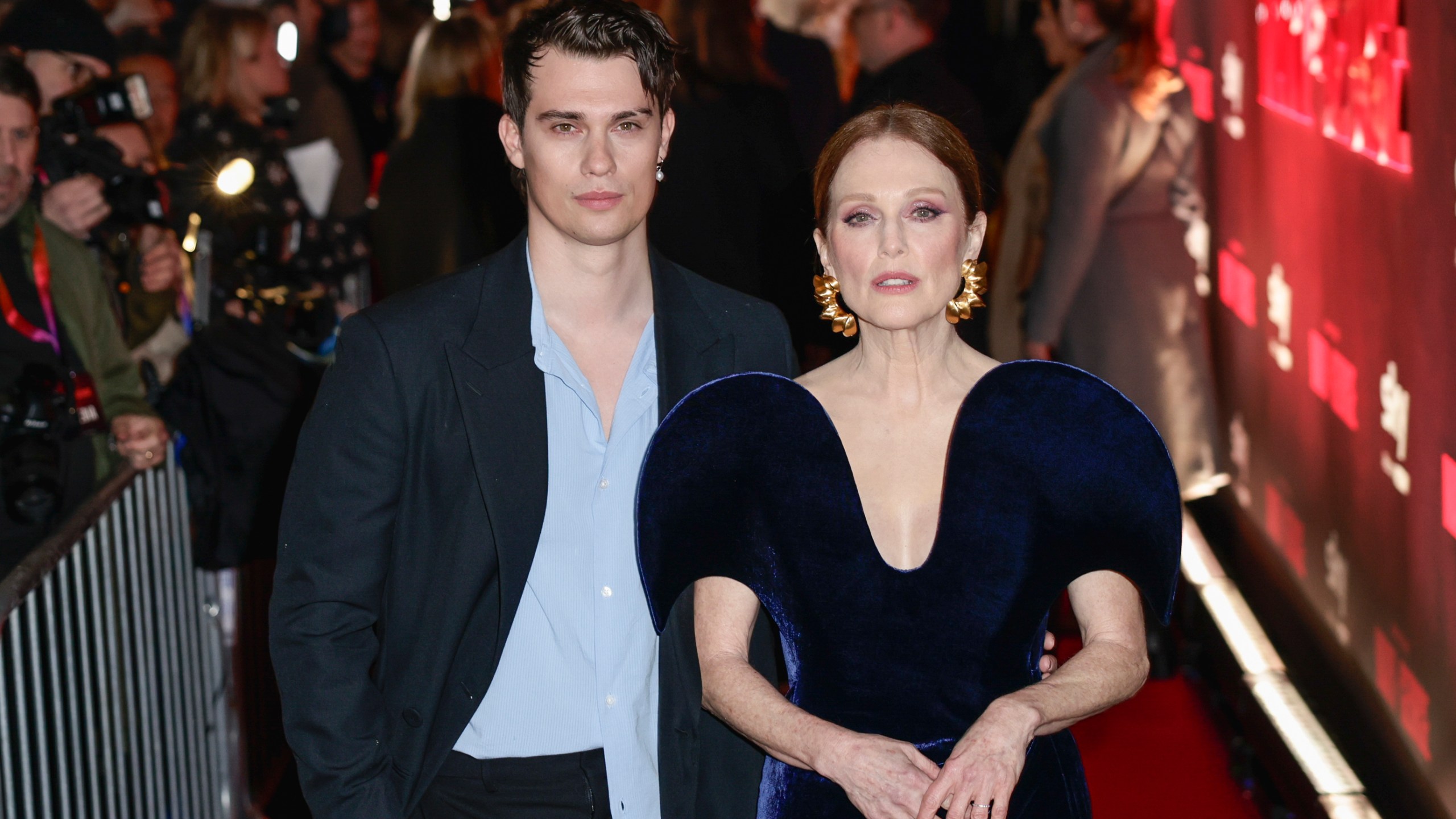 Nicholas Galitzine, left, and Julianne Moore pose for photographers upon arrival at the UK premiere of the television series 'Mary and George' in London, Wednesday, Feb. 28, 2024. (Photo by Millie Turner/Invision/AP)