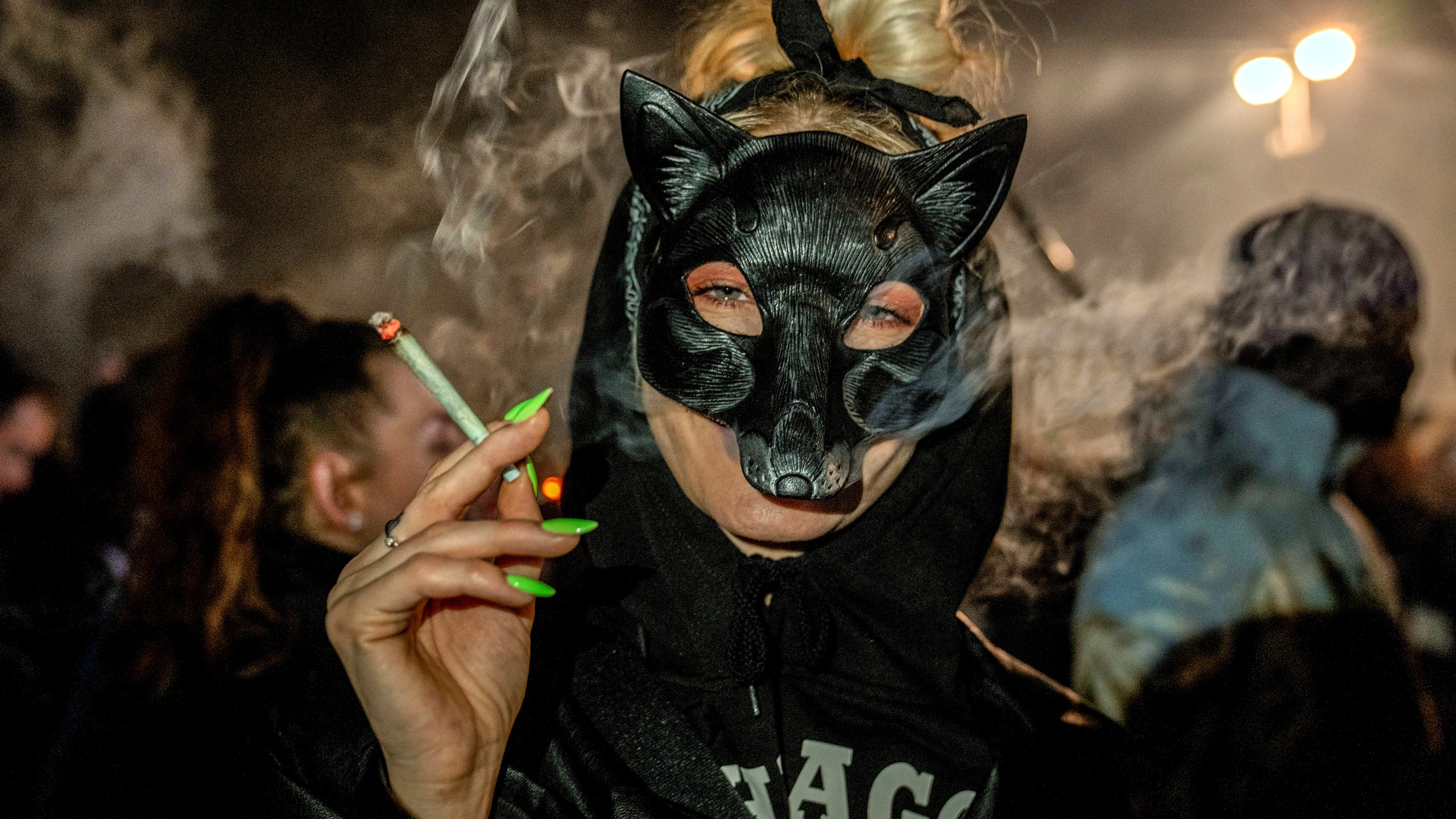 People smoke marijuana in front of the Brandenburg Gate during the 'Smoke-In' event in Berlin, Germany, Monday, April 1, 2024. Starting 1 April, Germany has legalised cannabis for personal use. As per the new law, Adults aged 18 and over will be allowed to carry up to 25 grams of cannabis for their own consumption. (AP Photo/Ebrahim Noroozi)