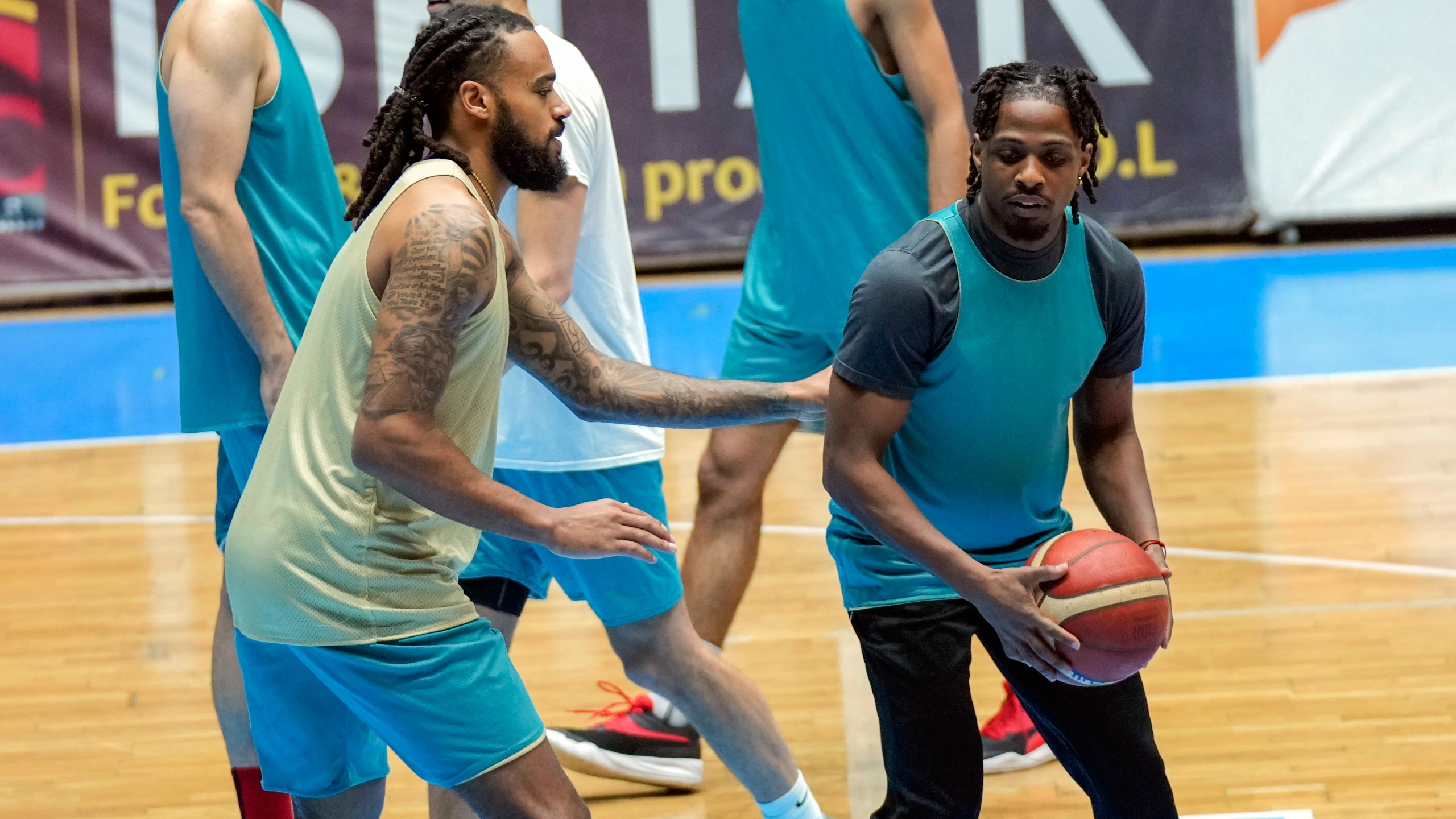 Isaac Banks, left, and, Uchenna Iroegbu American basketball players. with the Hashed al-Shaabi - the Popular Mobilization Forces - in the Iraqi Basketball Super League, take part in a team practice in Baghdad, Iraq, Thursday, March 21, 2024. U.S. players are in high demand on Iraqi basketball teams, even those whose owners have a tense relationship with Washington. (AP Photo/Hadi Mizban)