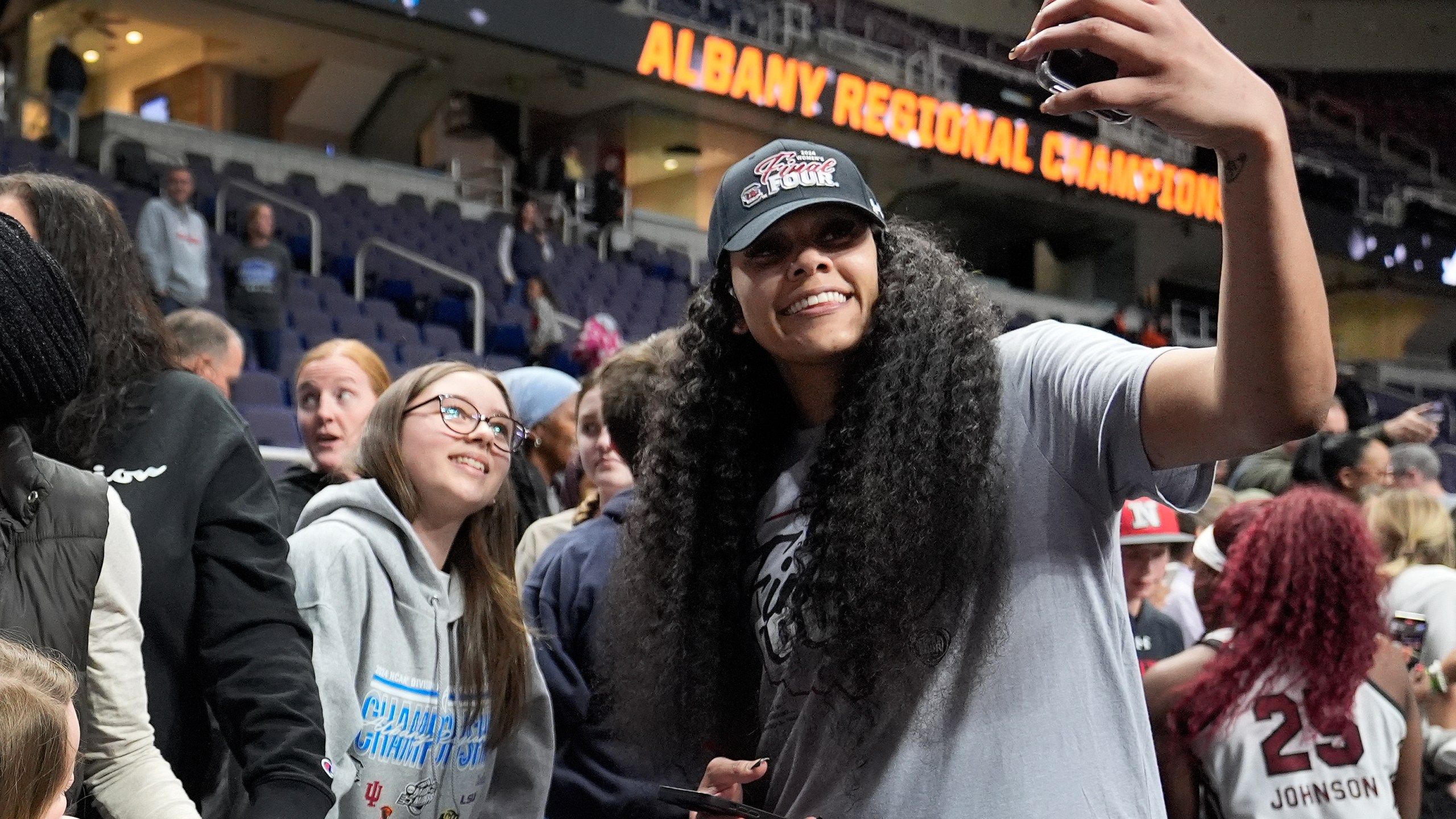 South Carolina center Kamilla Cardoso (10) takes a selfie with a fan after defeating Oregon State in an Elite Eight round college basketball game during the NCAA Tournament, Sunday, March 31, 2024, in Albany, N.Y. (AP Photo/Mary Altaffer)