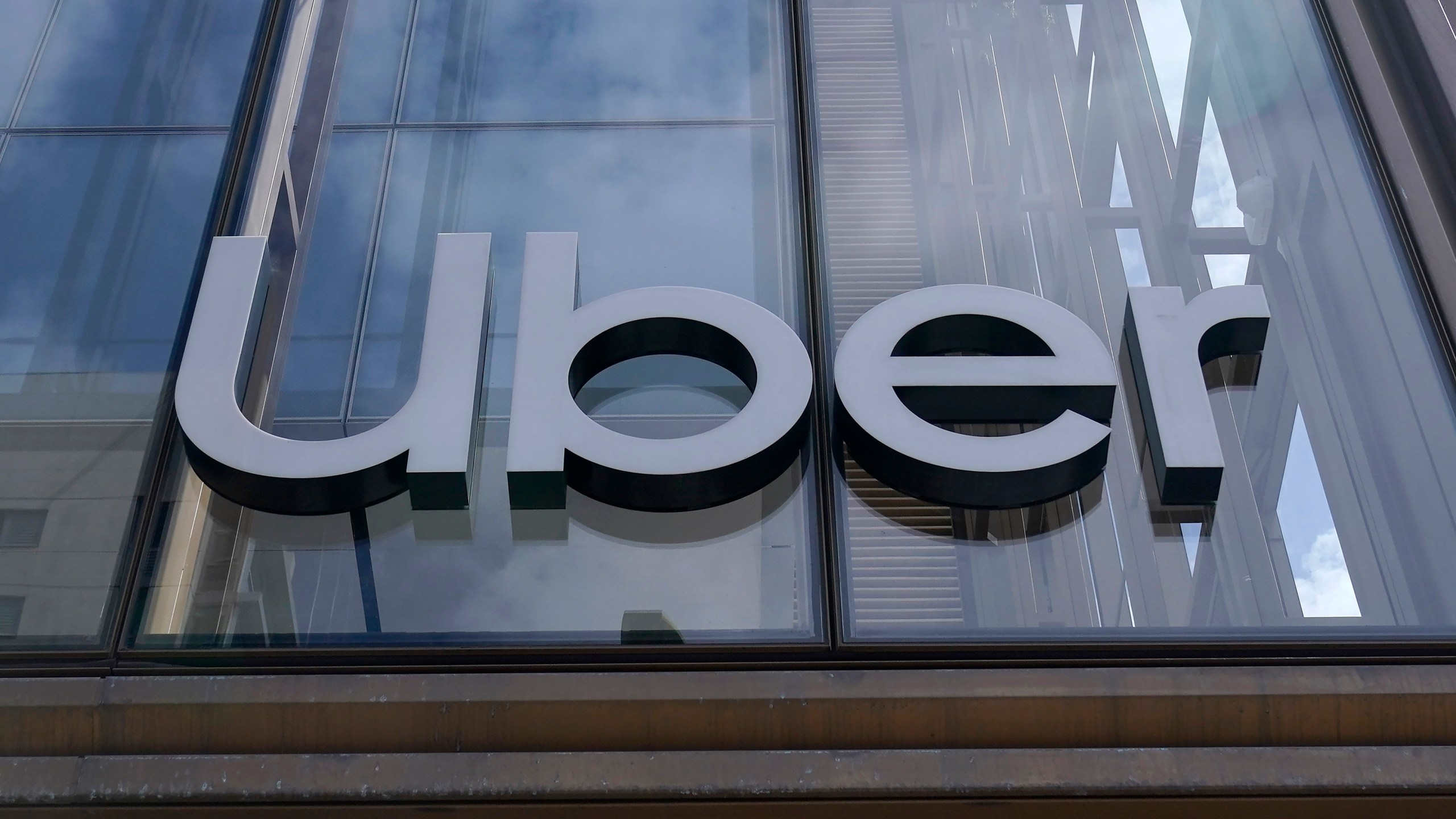 FILE - An Uber sign is displayed at the company's headquarters in San Francisco, Sept. 12, 2022. A failed Australian taxi industry disruptor has on Tuesday, April 2, 2024, begun its law suit against Uber claiming the U.S. giant began illegally operating ride sharing in Australia to gain an unfair advantage over competitors. (AP Photo/Jeff Chiu, File)