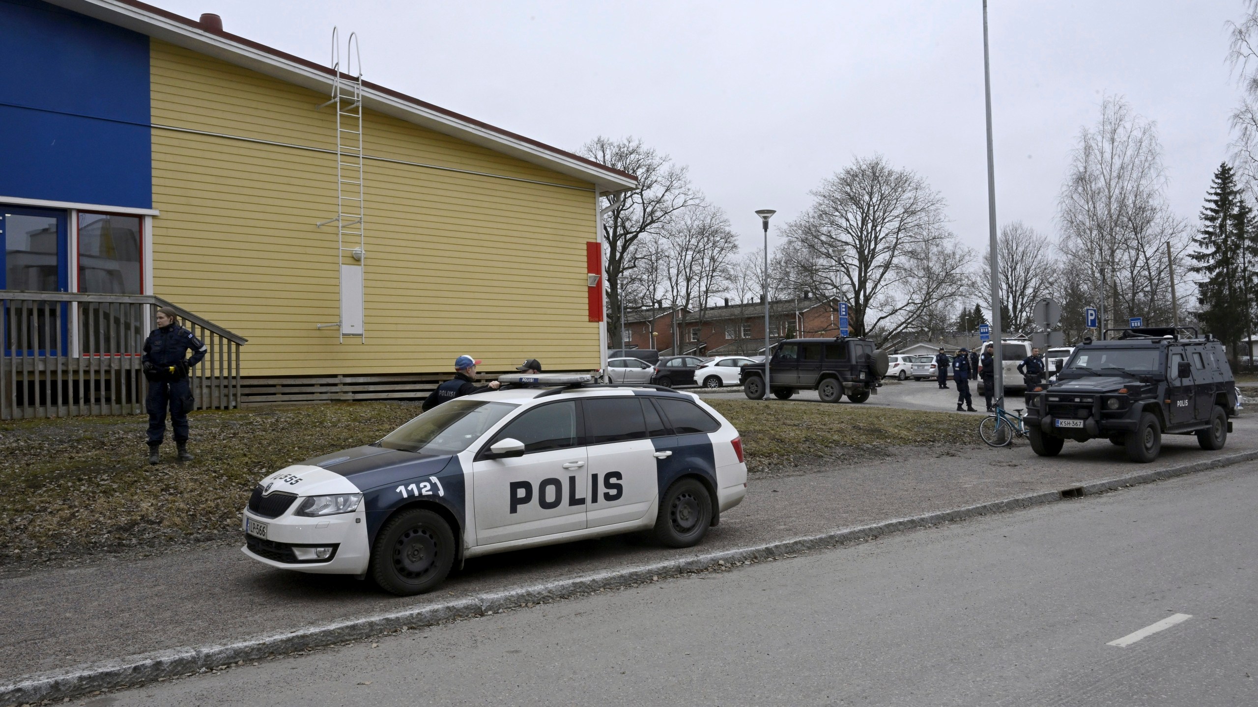 Police officers and vehicles at the scene of Viertola comprehensive school, in Vantaa, Finland, Tuesday, April 2, 2024. Finnish police say a number of people were wounded in a shooting at a school outside Helsinki and a suspect was detained. (Markku Ulander/Lehtikuva via AP)