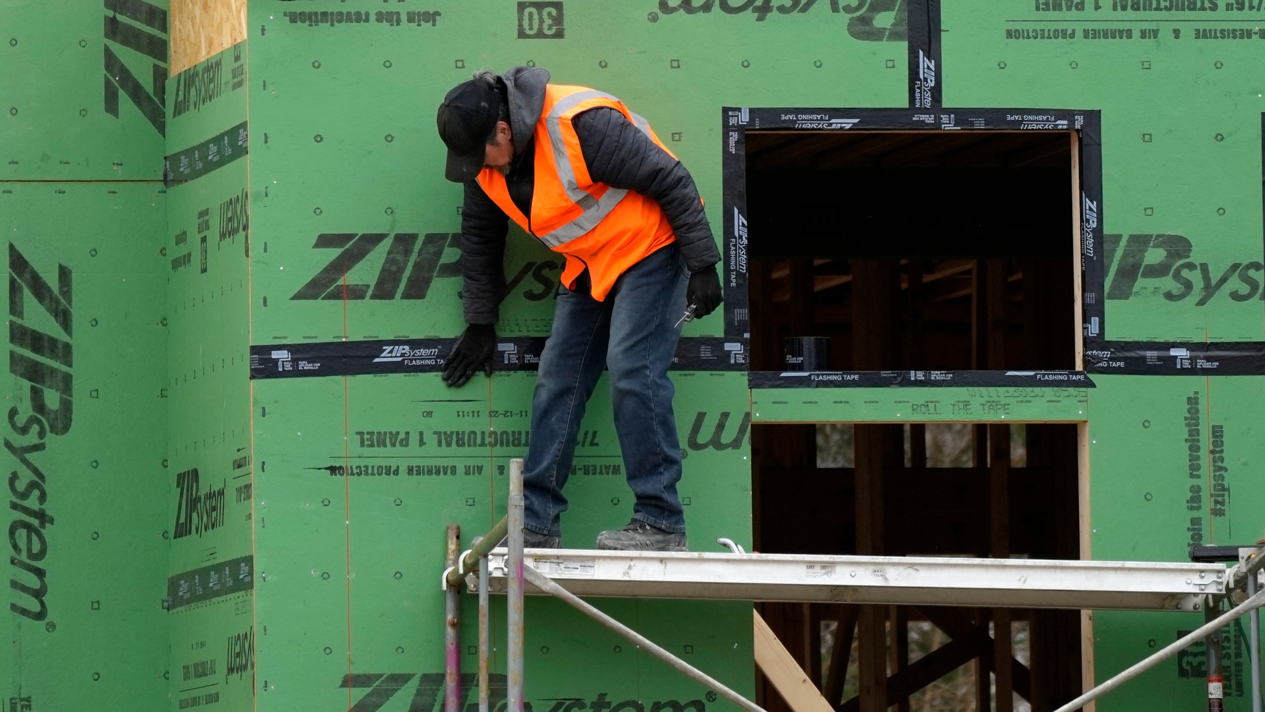A workman secures sheathing at a residential construction site in Mount Prospect, Ill., Monday, March 18, 2024. On Tuesday, April 2, 2024, the Labor Department reports on job openings and labor turnover for February. (AP Photo/Nam Y. Huh)