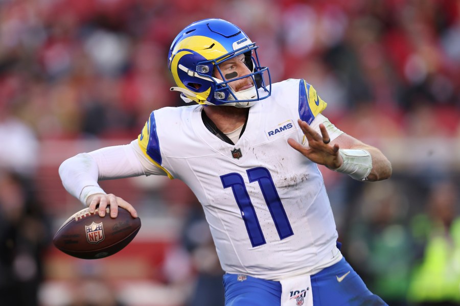 FILE - Los Angeles Rams quarterback Carson Wentz (11) passes against the San Francisco 49ers during the second half of an NFL football game in Santa Clara, Calif., Sunday, Jan. 7, 2024. Carson Wentz has agreed to a one-year contract with the Kansas City Chiefs, a person familiar with the deal told The Associated Press on Tuesday, April 2, 2024. (AP Photo/Jed Jacobsohn, File)