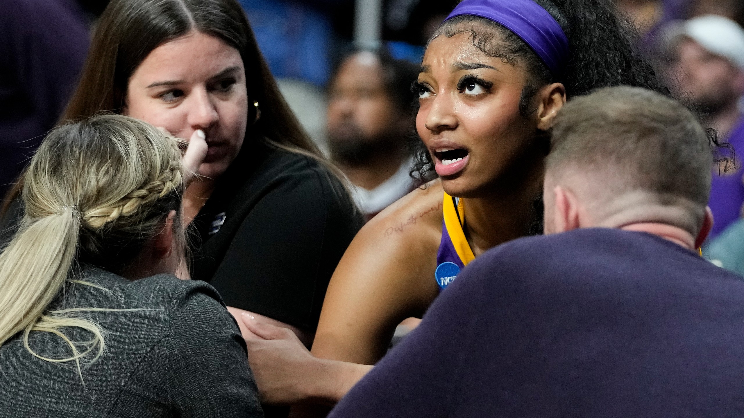 LSU forward Angel Reese (10) talks with coaches on the bench during the first half of an Elite Eight round college basketball game against Iowa during the NCAA Tournament, Monday, April 1, 2024, in Albany, N.Y. (AP Photo/Mary Altaffer)