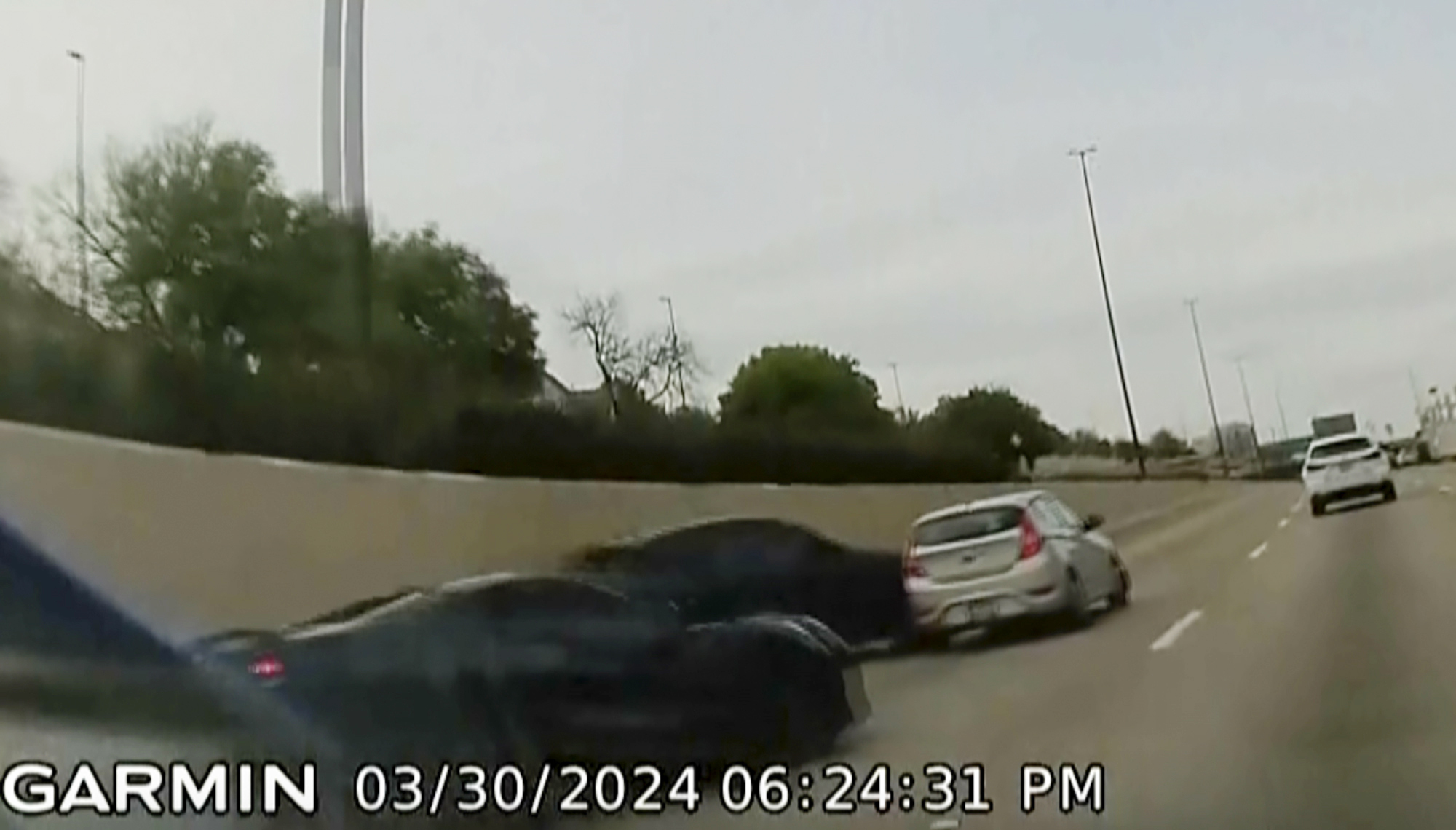 In this screen grab taken from dash camera video provided by Bill Nabors, two speeding sports cars, left and second from left, cause a chain-reaction crash on the North Central Expressway, in Dallas, Saturday, March 30, 2024. (Bill Nabors via AP)