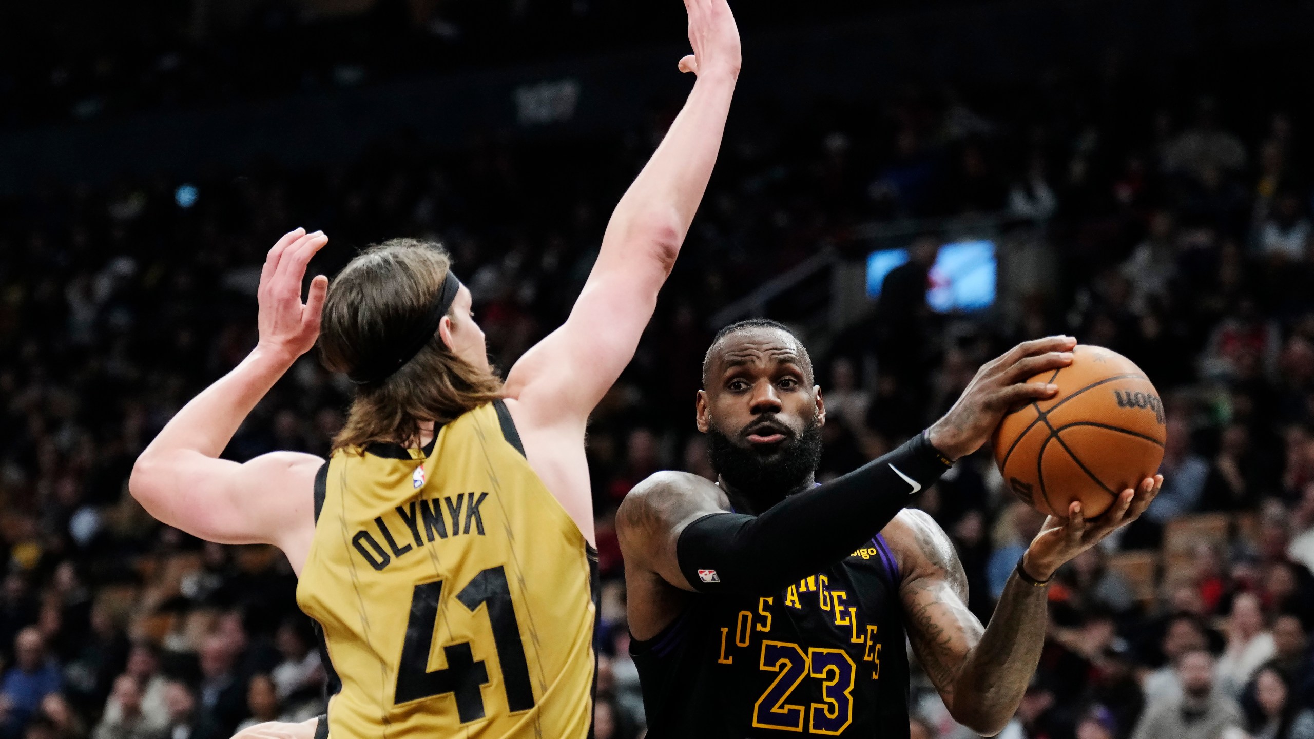 Los Angeles Lakers forward LeBron James (23) tries to get past Toronto Raptors forward Kelly Olynyk (41) during the second half of an NBA basketball game Tuesday, April 2, 2024, in Toronto. (Frank Gunn/The Canadian Press via AP)