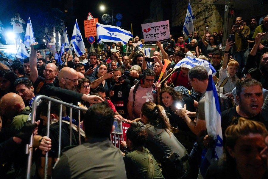 Police try to push back demonstrators in a protest against Israeli Prime Minister Benjamin Netanyahu's government and call for the release of hostages held in the Gaza Strip by the Hamas militant group in Jerusalem, Tuesday, April 2, 2024. (AP Photo/Ohad Zwigenberg)