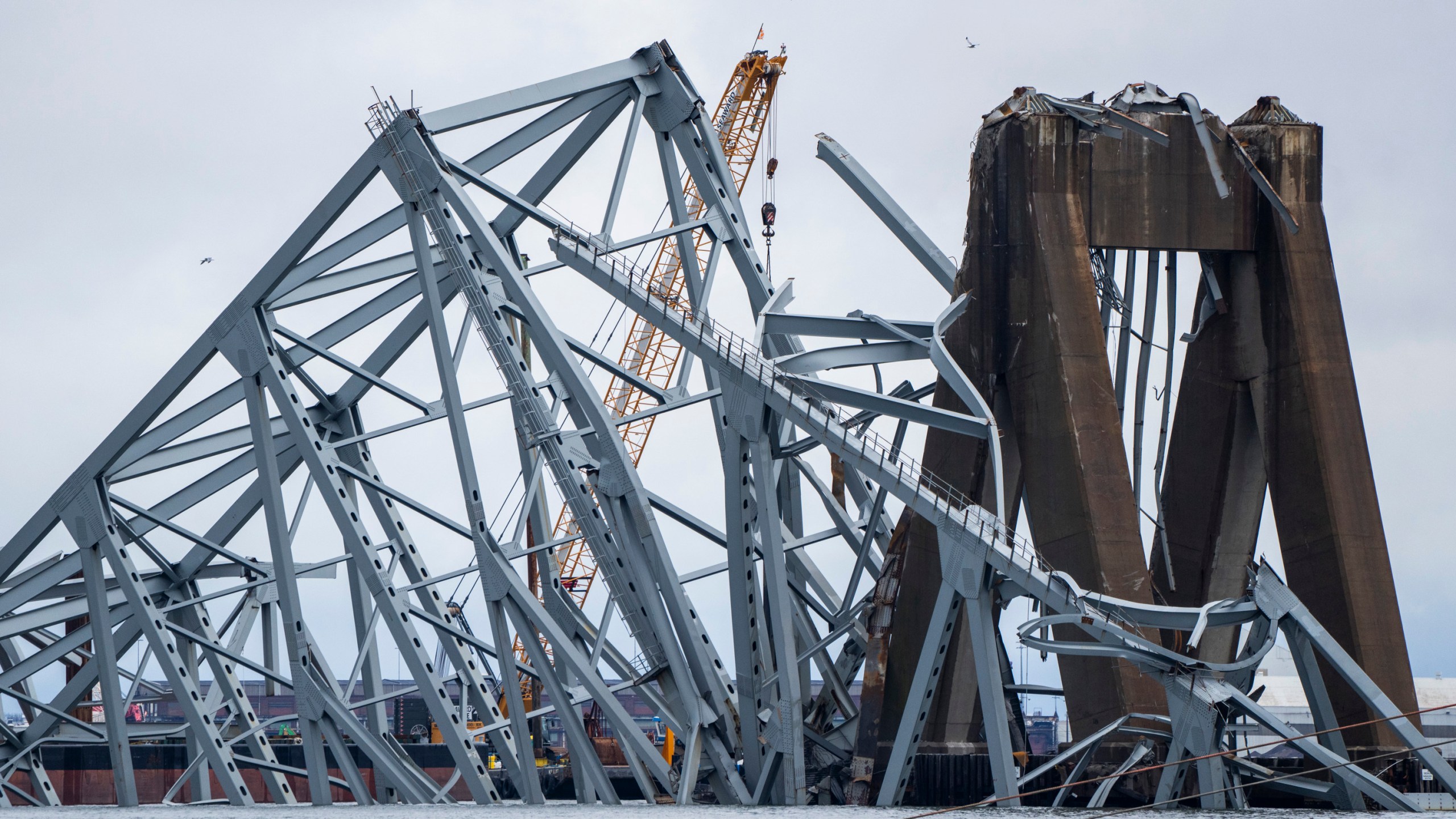 A section of the damaged and collapsed Francis Scott Key Bridge is seen, in the Baltimore port, Monday, April 1, 2024. (Kaitlin Newman/The Baltimore Banner via AP)