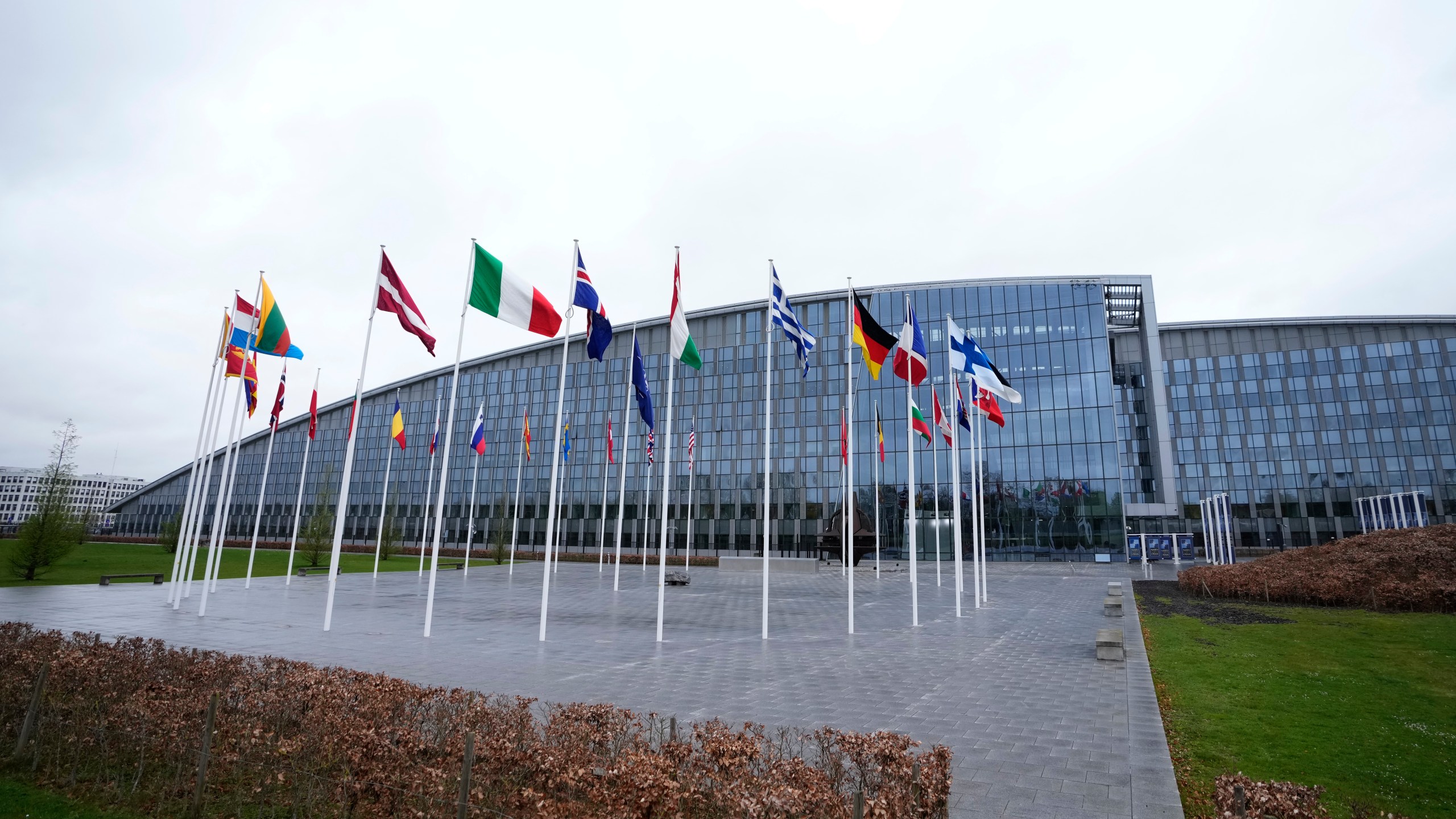 Flags of NATO member countries flap in the wind outside NATO headquarters in Brussels, Wednesday, April 3, 2024. NATO foreign ministers gathered in Brussels on Wednesday to debate plans to provide more predictable, longer-term support to Ukraine. (AP Photo/Virginia Mayo)