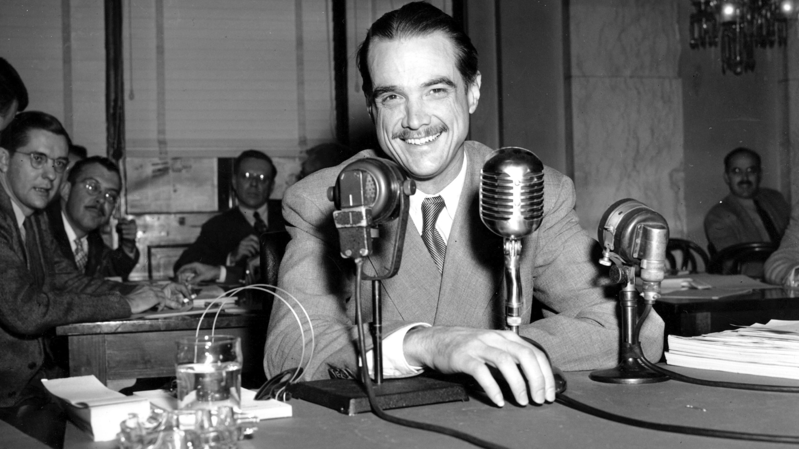 FILE - Howard Hughes smiles as he sits in the witness chair before reading a statement at the Senate War Investigation Subcommittee hearing in Washington, Nov. 15, 1947. Hughes played a supporting role in the CIA’s effort to retrieve part of a sunken Soviet submarine in 1974 with a specialized ship that was built to retrieve the sub and was called the Hughes Glomar Explorer. (AP Photo/File)