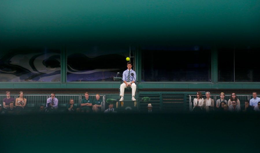 FILE - An umpire watches the ball as a match unfolds on Court 18, as seen through wooden slats, at the All England Lawn Tennis Championships in Wimbledon, London, Wednesday, June 26, 2013. (AP Photo/Anja Niedringhaus, File)