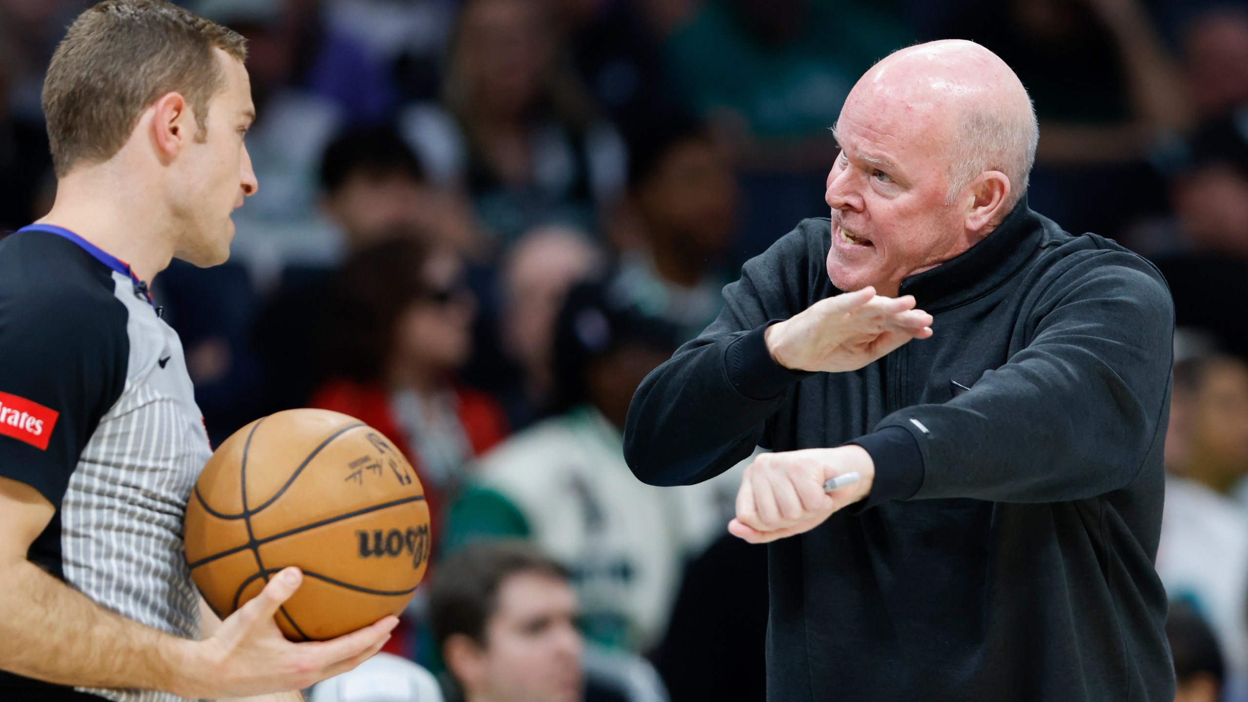 Charlotte Hornets head coach Steve Clifford, right, argues with referee Brandon Schwab for a foul during the first half of an NBA basketball game against the Boston Celtics in Charlotte, N.C., Monday, April 1, 2024. Clifford received a technical foul. (AP Photo/Nell Redmond)