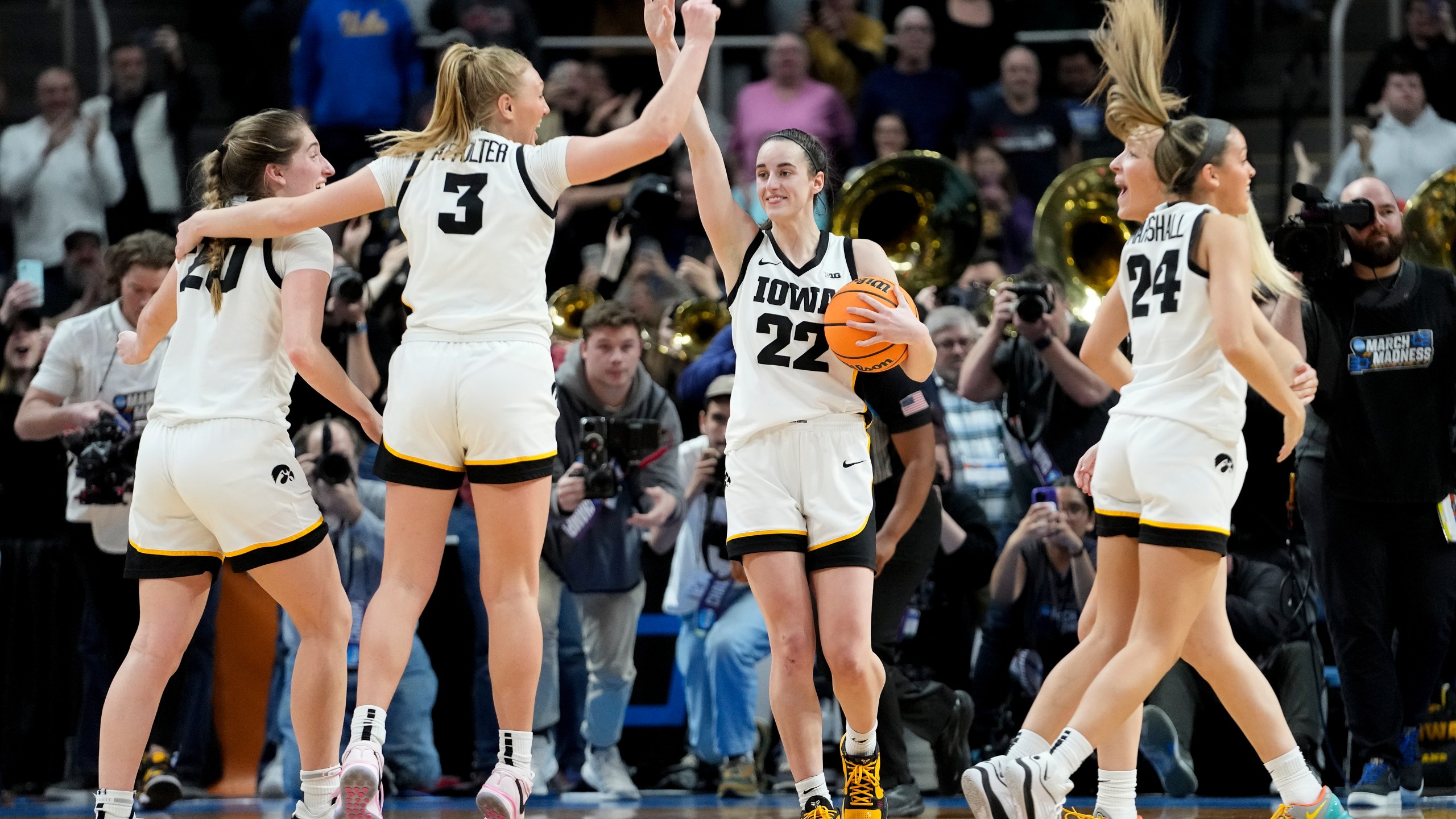 Iowa guard Caitlin Clark (22) celebrates with teammates after defeating LSU in an Elite Eight round college basketball game during the NCAA Tournament, Monday, April 1, 2024, in Albany, N.Y. (AP Photo/Mary Altaffer)