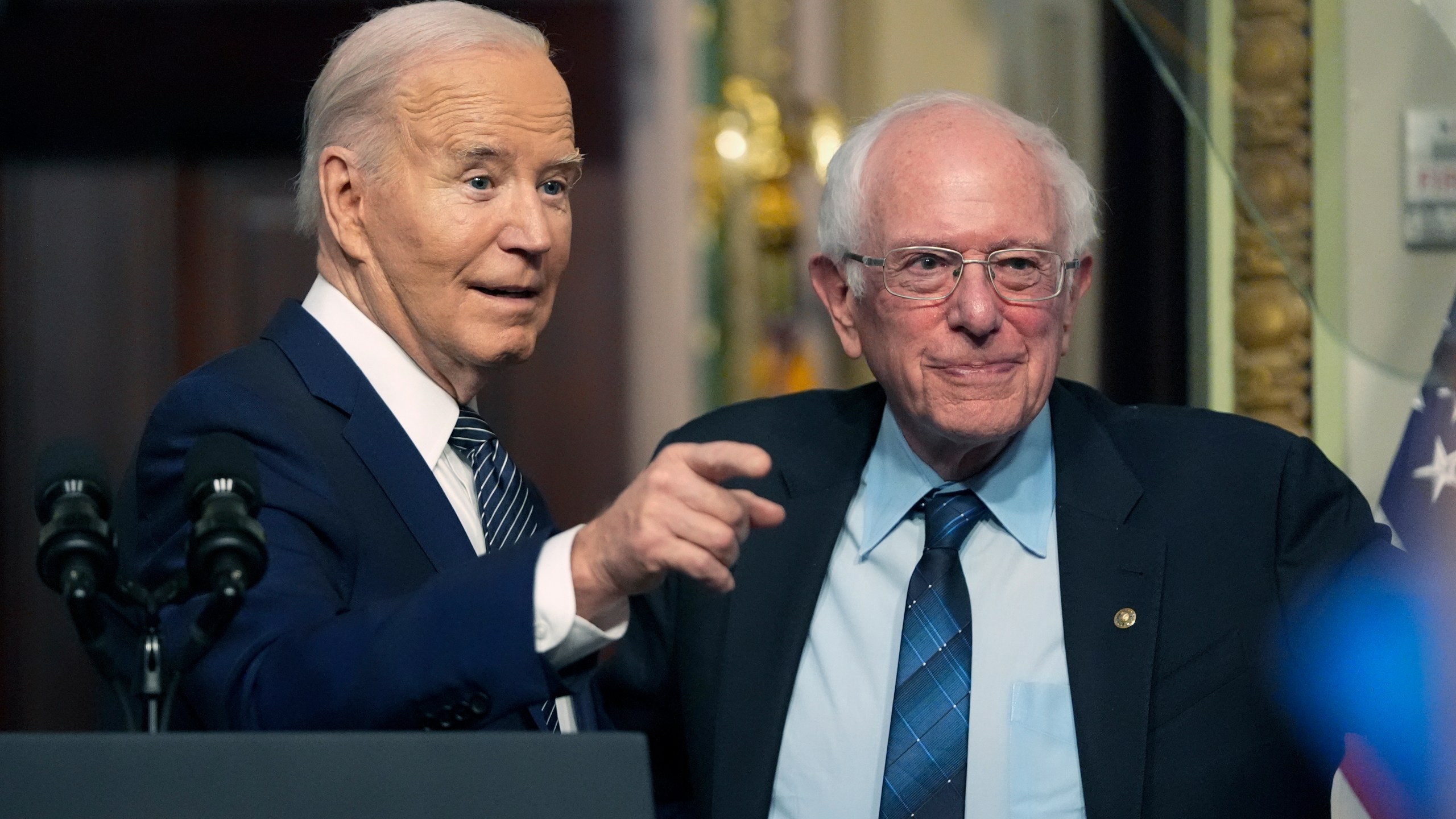 President Joe Biden stands with Sen. Bernie Sanders, I-Vt., after speaking about lowering health care costs in the Indian Treaty Room at the Eisenhower Executive Office Building on the White House complex in Washington, Wednesday, April 3, 2024. (AP Photo/Mark Schiefelbein)