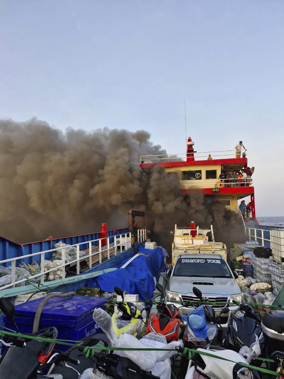 Smoke rises from a ferry in Surat Thani province, Thailand, Thursday, April 4, 2024. The ferry caught fire off the southern Thailand coast on Thursday morning while carrying more than a hundred people, sending panicking passengers to jump into the sea to escape the raging blaze. (Maitree Promjampa via AP)