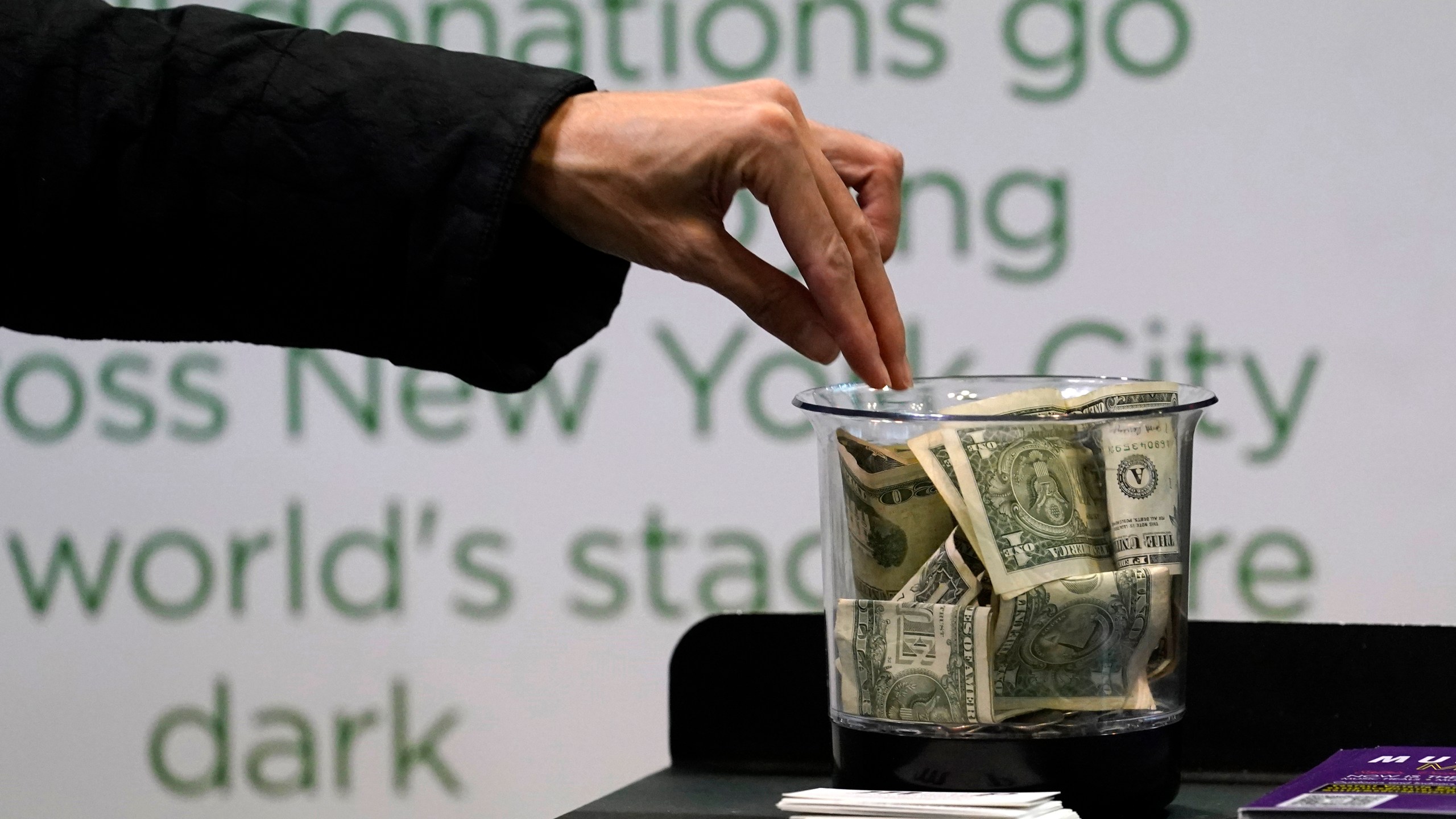 FILE - Money is donated for out of work musicians on March 18, 2021, in New York. At tax time, the three biggest potential deductions for most people are mortgage insurance, charitable donations in cash or in property, and eligible state and local taxes. (AP Photo/Kathy Willens, File)