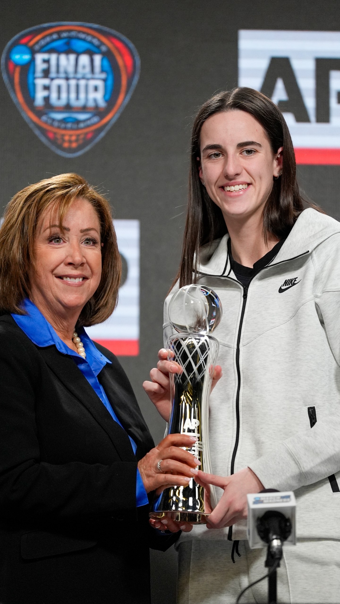 AP's Nancy Nussbaum poses for a photo with Iowa's Caitlin Clark after giving her the AP NCAA Women's Player of the Year award Thursday, April 4, 2024, in Cleveland. (AP Photo/Morry Gash)