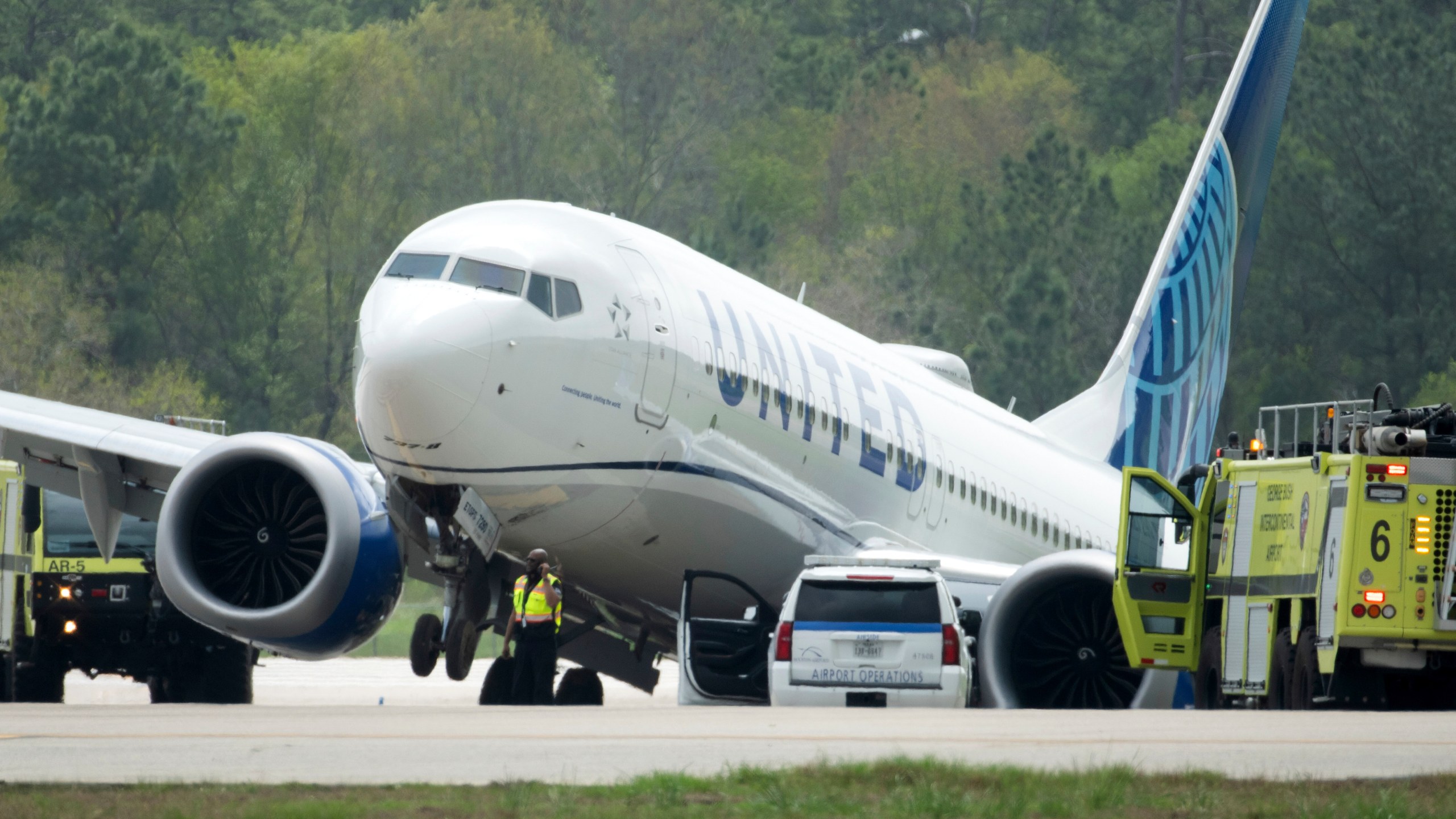 FILE - A United Airlines jet is seen after leaving the taxiway, March 8, 2024, at George Bush Intercontinental Airport in Houston. Federal officials are issuing a preliminary report about the United jet that slid off a taxiway at a Houston airport last month. According to a report, Thursday, April 4, 2024, by the National Transportation Safety Board, the United captain said the brakes seemed less effective than normal. He says the plane and brake pedals shook violently just before the plane slid off the taxiway into a grassy area. (Jason Fochtman/Houston Chronicle via AP, file)