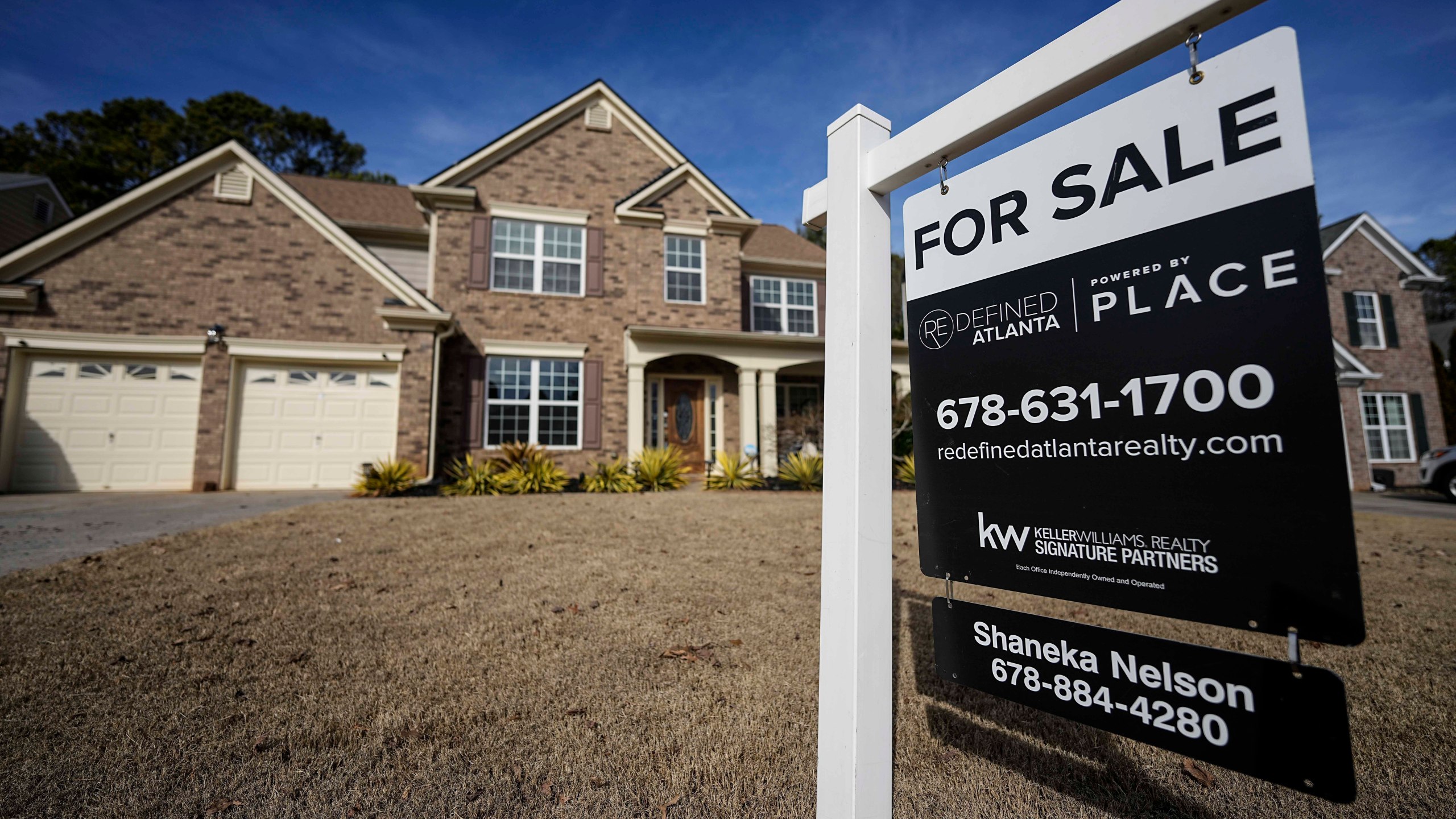 FILE - A sign announcing a home for sale is posted outside a home, Feb. 1, 2024, in Aceworth, Ga., near Atlanta. One of the reasons for the sharp run-up in home loan borrowing costs the last couple of years has been a wider-than-normal gap between long-term mortgage rates and the yield on the benchmark U.S. government bond. (AP Photo/Mike Stewart)