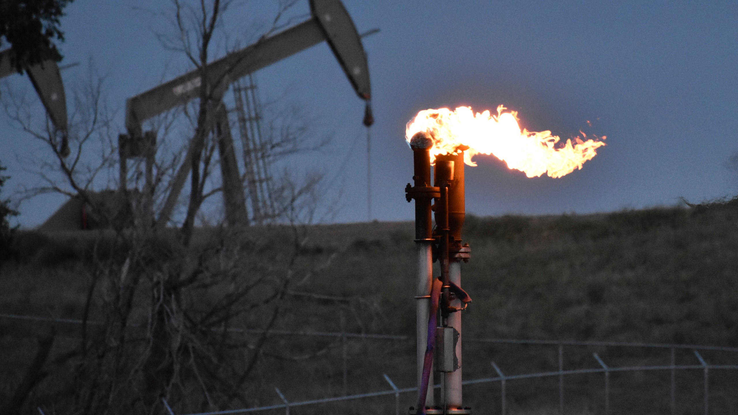 FILE - A flare burns at a well pad Aug. 26, 2021, near Watford City, N.D. The levels of the crucial heat-trapping gases in the atmosphere reached historic highs in 2023, growing at near-record fast paces, according to the U.S. National Oceanic and Atmospheric Administration. (AP Photo/Matthew Brown, File)