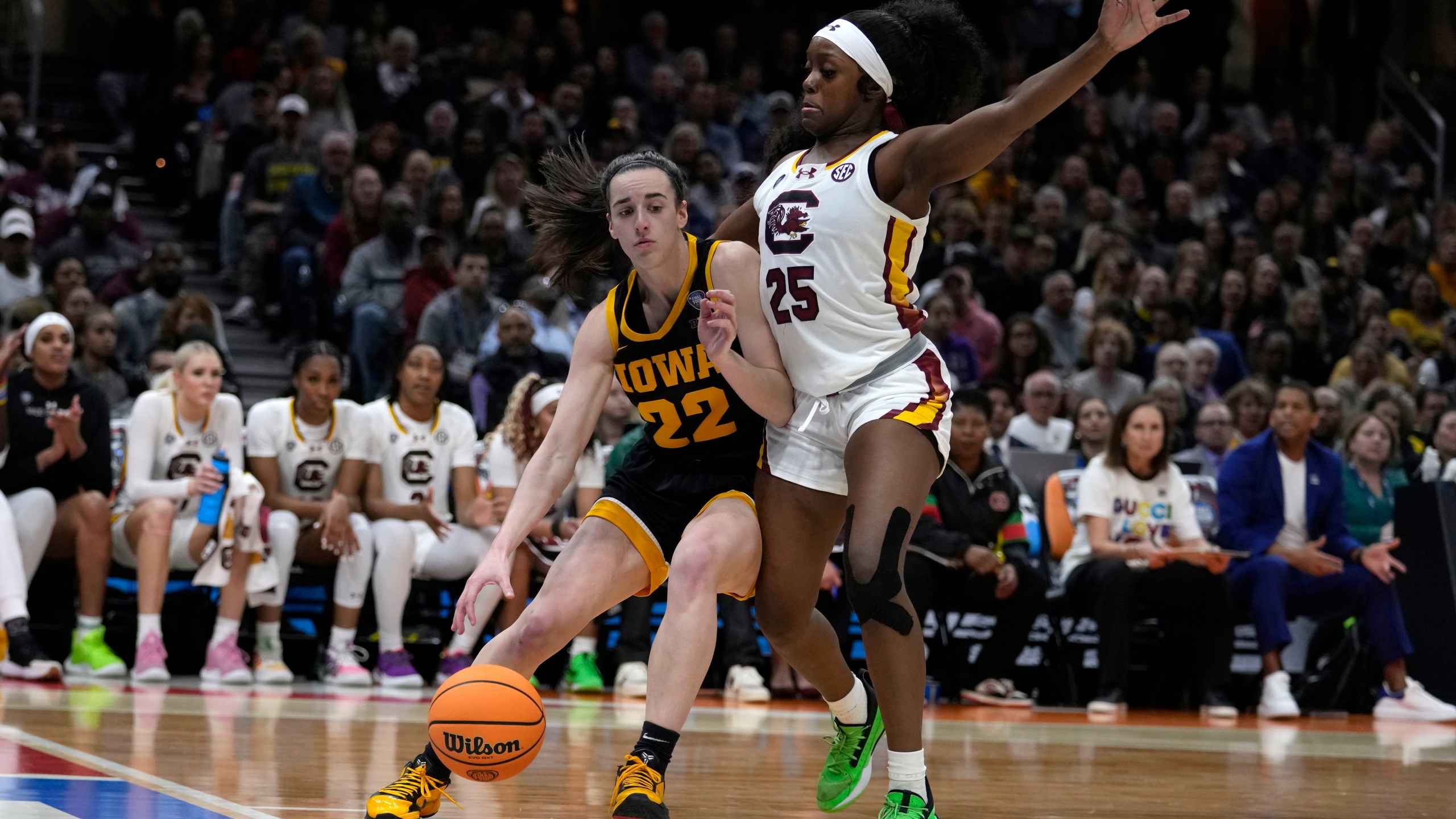 Iowa guard Caitlin Clark (22) drives past South Carolina guard Raven Johnson (25) during the first half of the Final Four college basketball championship game in the women's NCAA Tournament, Sunday, April 7, 2024, in Cleveland. (AP Photo/Carolyn Kaster)