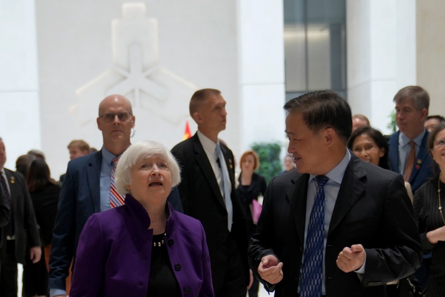 U.S. Treasury Secretary Janet Yellen, left, walks with Governor of the People's Bank of China Pan Gongsheng as they meet at the People's Bank of China in Beijing Monday, April 8, 2024. (AP Photo/Tatan Syuflana, Pool)