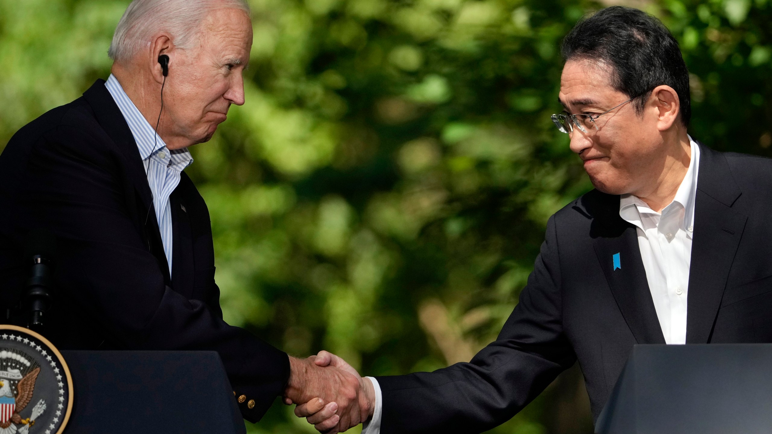 FILE - U.S. President Joe Biden, left, shakes hands with Japan's Prime Minister Fumio Kishida during a joint news conference with South Korean President Yoon Suk Yeol, not visible, on Aug. 18, 2023, at Camp David, the presidential retreat, near Thurmont, Md. Prime Minister Kishida is making an official visit to the United States this week. He will hold a summit with President Biden that's meant to achieve a major upgrading of their defense alliance.(AP Photo/Andrew Harnik, File)