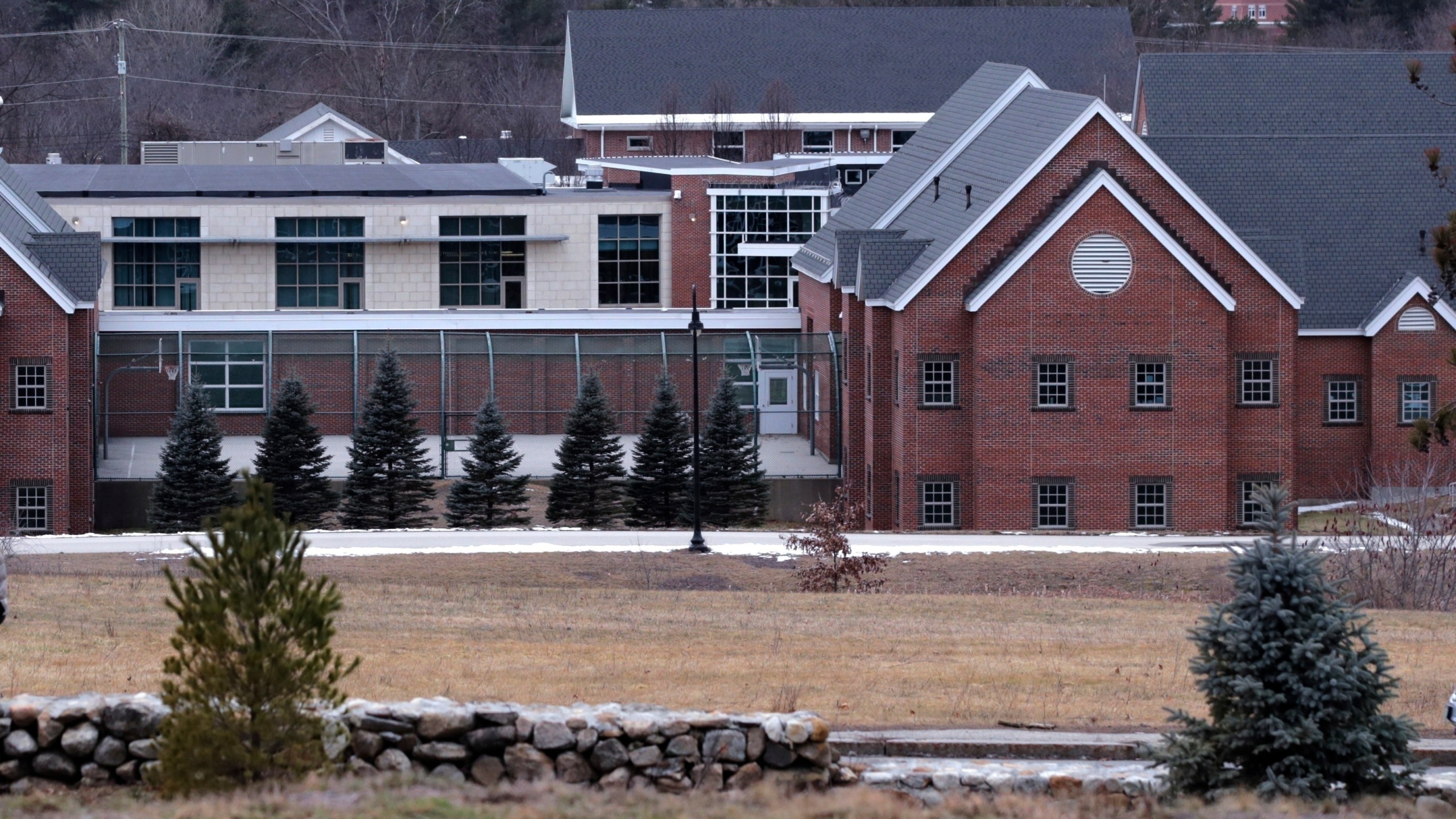 FILE - The Sununu Youth Services Center in Manchester, N.H., stands among trees, Jan. 28, 2020. Karen Lemoine, a woman who worked at New Hampshire’s youth detention center three decades ago, testified Wednesday, April 10, 2024, that supervisors and staff were dismissive at best and menacing at worst when she reported suspected abuse. (AP Photo/Charles Krupa, File)