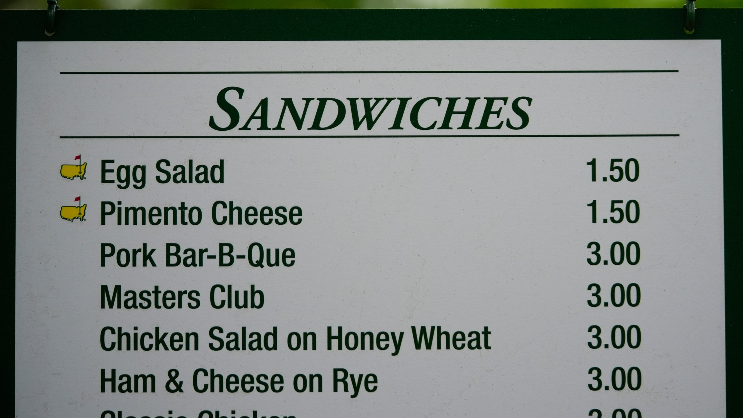 The prices for sandwiches are posted on a sign during a practice round in preparation for the Masters golf tournament at Augusta National Golf Club Tuesday, April 9, 2024, in Augusta, Ga. (AP Photo/Matt Slocum)