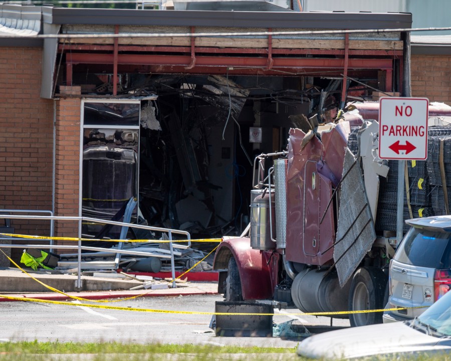 A stolen 18-wheeler crashed into a Texas Department of Public Safety office on US-290 in Brenham, Texas on Friday, April 12, 2024. The driver of a stolen semitrailer intentionally rammed it into the Texas public safety office in a rural town west of Houston on Friday, injuring multiple people, according to a state lawmaker. (Meredith Seaver/College Station Eagle via AP)