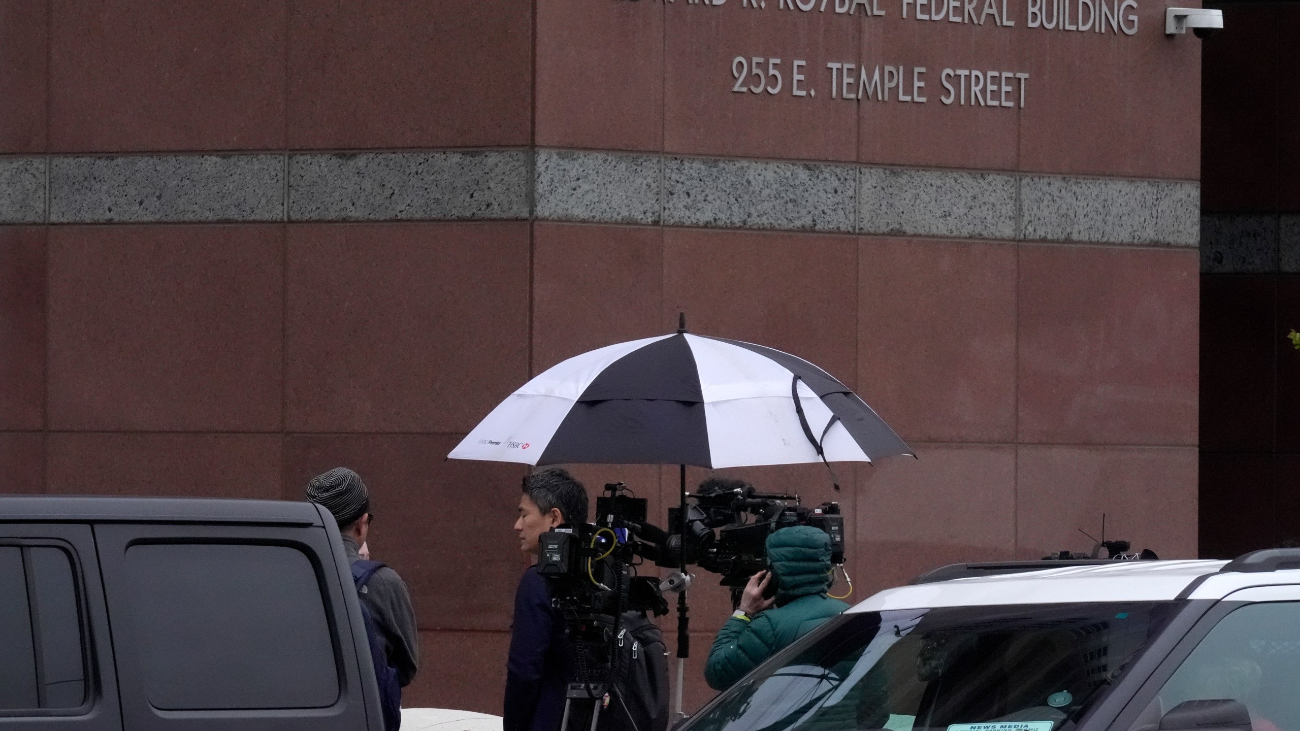 A news crew waits outside federal court for Ippei Mizuhara, the former longtime interpreter for Los Angeles Dodgers star Shohei Ohtani, Friday, April 12, 2024, in Los Angeles. Mizuhara is charged with federal bank fraud, alleging that he stole more than $16 million from the Japanese sensation to cover gambling bets and debts, federal authorities said. (AP Photo/Damian Dovarganes)