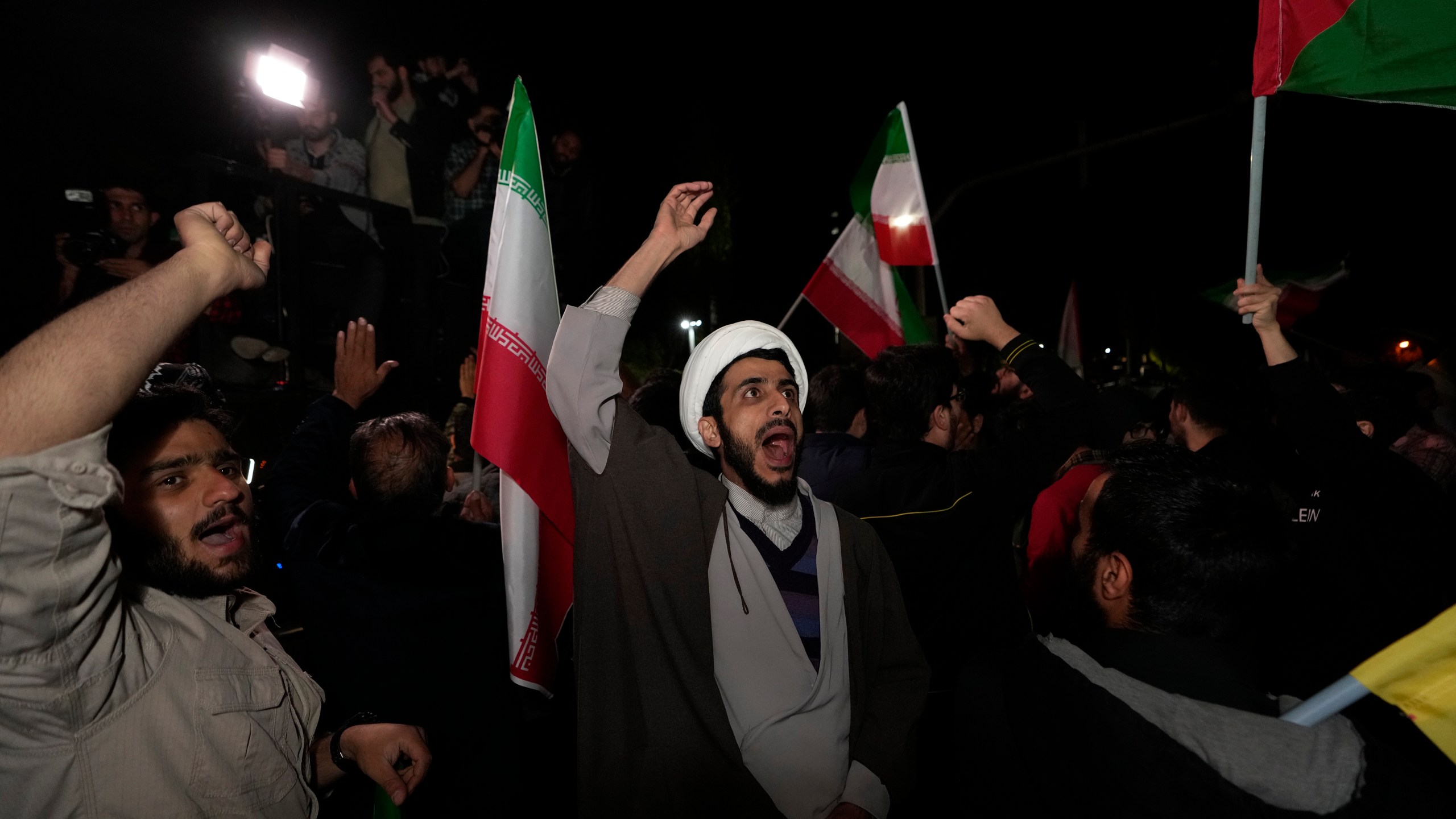 Iranian demonstrators chant slogans during their anti-Israeli gathering in front of the British Embassy in Tehran, Iran, early Sunday, April 14, 2024. Iran launched its first direct military attack against Israel on Saturday. (AP Photo/Vahid Salemi)