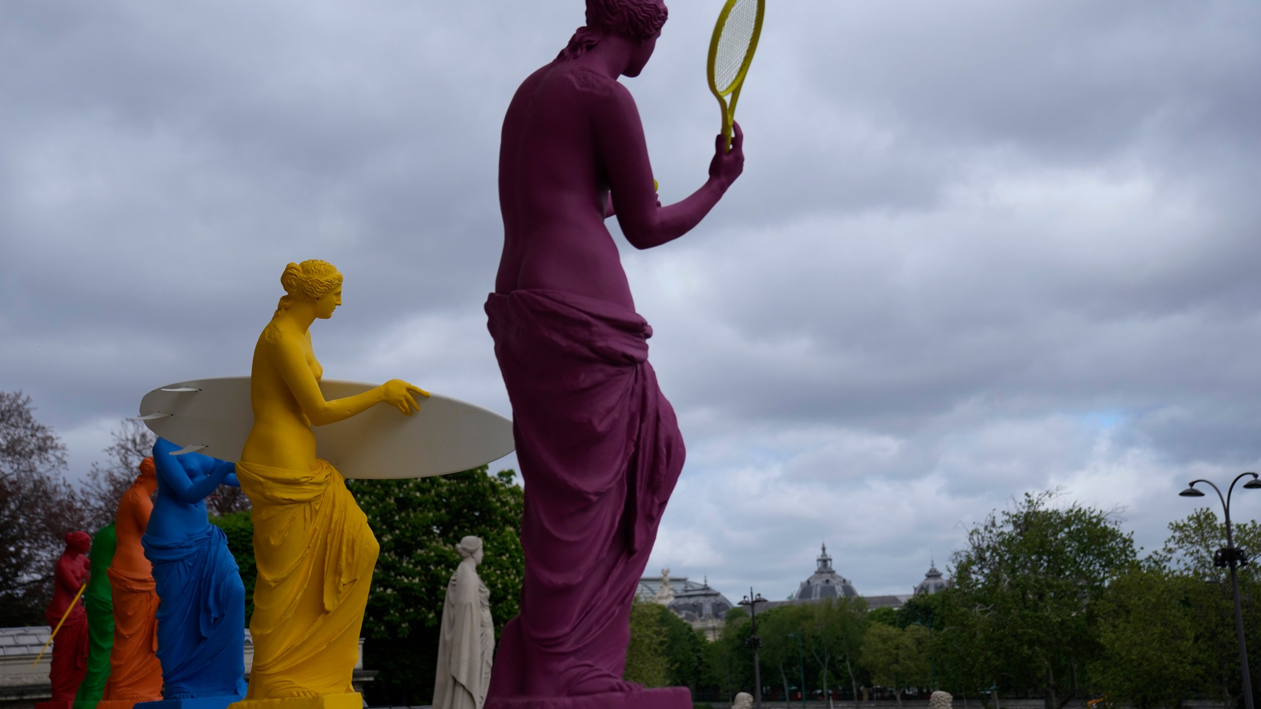 Copies of one of the most famous Greek statues, the Venus of Milo, are installed on the steps of the French National Assembly in Paris, France, Monday, April 15, 2024, to celebrate the Olympic spirit. The Venus, by artist Laurent Perbos, has regained her arms and is now equipped with the attributes of six sporting disciplines. (AP Photo/Christophe Ena)