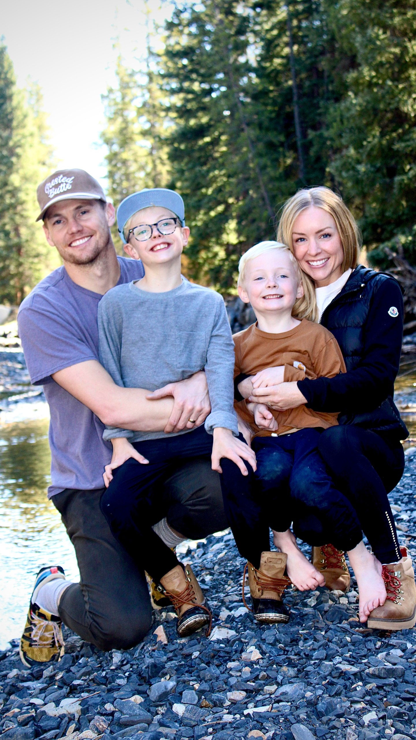 This undated photo released by Cameron Clifford, shows the Clifford family, from left to right; Cameron, Cal, Lyle and Kari who own Terrance, the pet octopus his son Cal adopted at their home in Edmond, Okla. The family soon learned that Terrance was female as she laid 50 eggs that later hatched, with nearly half of them surviving. Although female octopuses usually die soon after laying their eggs, Terrance is still alive four months later. (Cameron Clifford via AP)