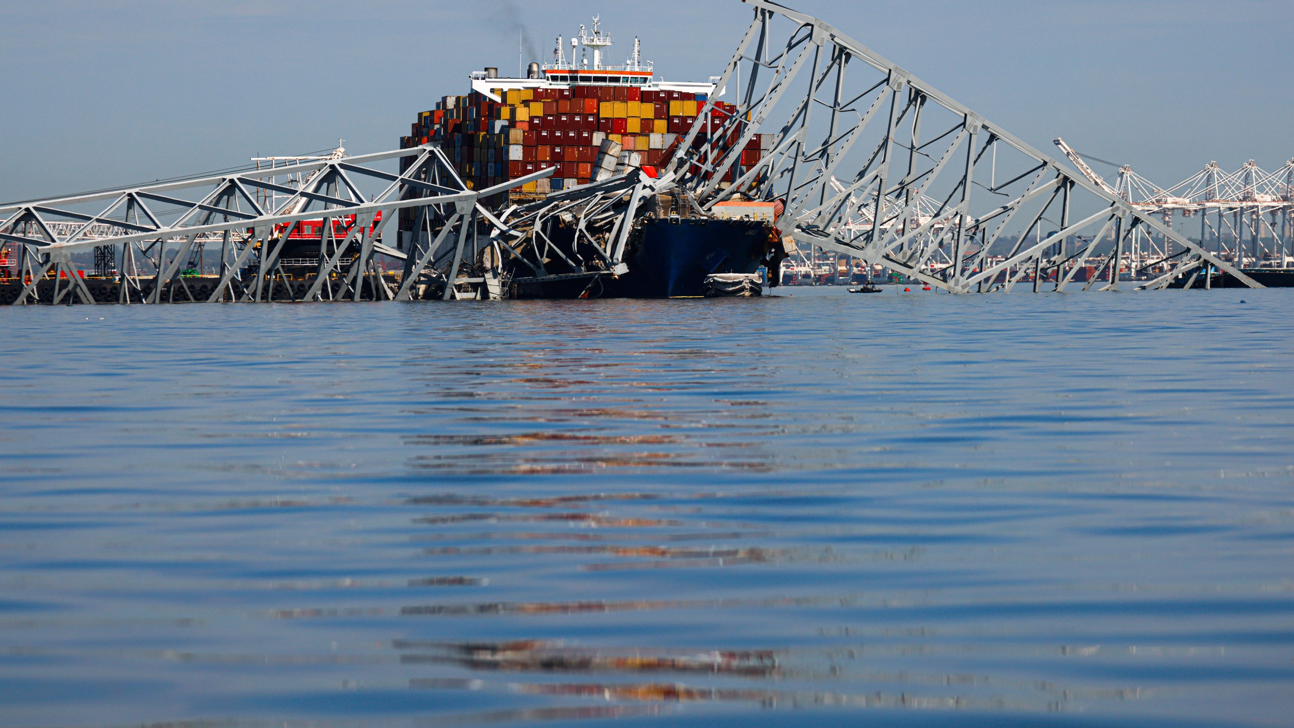 The collapsed Francis Scott Key Bridge lays on top of the container ship Dali, Monday, April 15, 2024, in Baltimore. The FBI confirmed that agents were aboard the Dali conducting court-authorized law enforcement activity. (AP Photo/Julia Nikhinson)