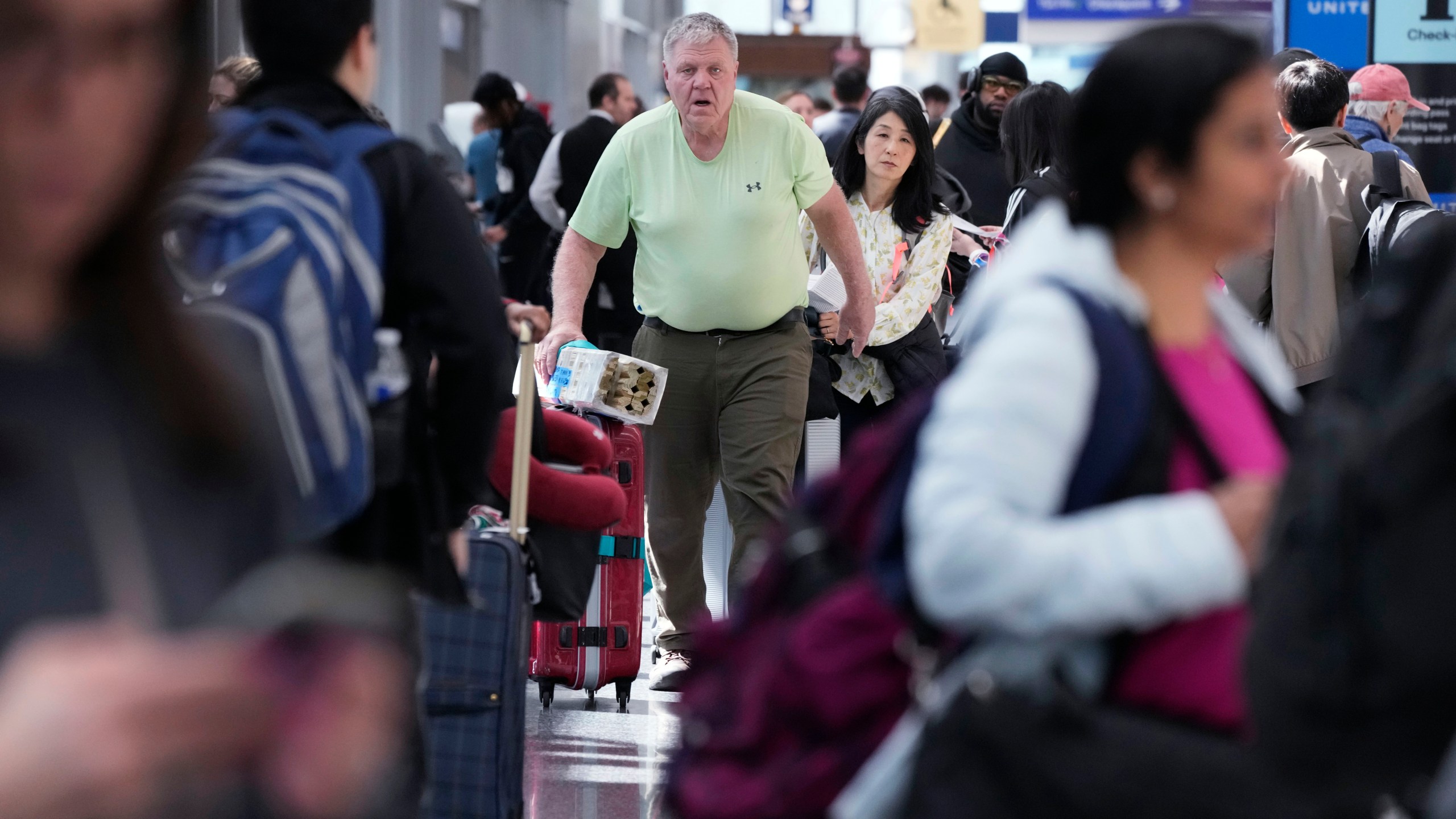 Travelers walk through Terminal 1 at O'Hare International Airport in Chicago, Monday, April 15, 2024. Pro-Palestinian demonstrators blocked a freeway leading to three Chicago O'Hare International Airport terminals Monday morning, temporarily stopping vehicle traffic into one of the nation's busiest airports and causing headaches for travelers. (AP Photo/Nam Y. Huh)