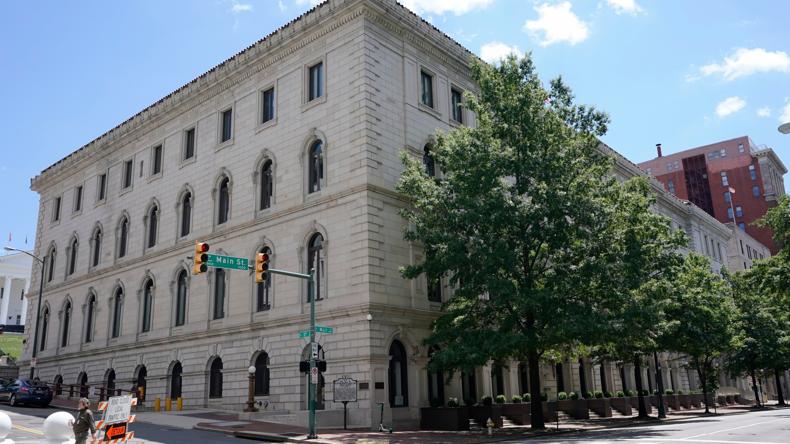 FILE - A pedestrian passes by the US 4th Circuit Court of Appeals Courthouse on Main Street in Richmond, Va., Wednesday, June 16, 2021. West Virginia's transgender sports ban violates the rights of a teen athlete under Title IX, the federal civil rights law that prohibits sex-based discrimination in schools, an appeals court ruled Tuesday, April 16, 2024. The 4th U.S. Circuit Court of Appeals ruled 2-1 that the law cannot be applied to a 13-year-old who has been taking puberty-blocking medication and publicly identified as a girl since she was in the third grade. (AP Photo/Steve Helber, File)