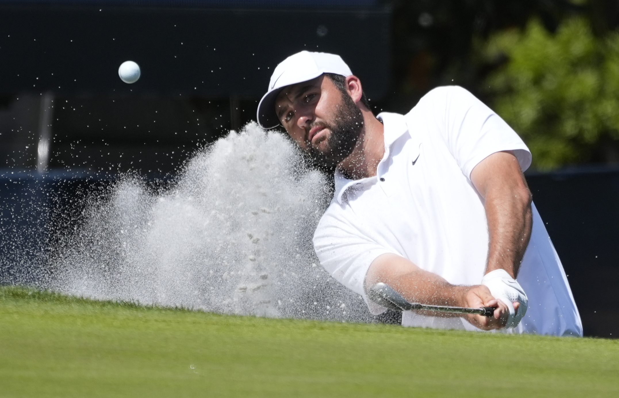 FILE - Scottie Scheffler hits out of the sand on the second green during the final round of The Players Championship golf tournament Sunday, March 17, 2024, in Ponte Vedra Beach, Fla. (AP Photo/Marta Lavandier, File)