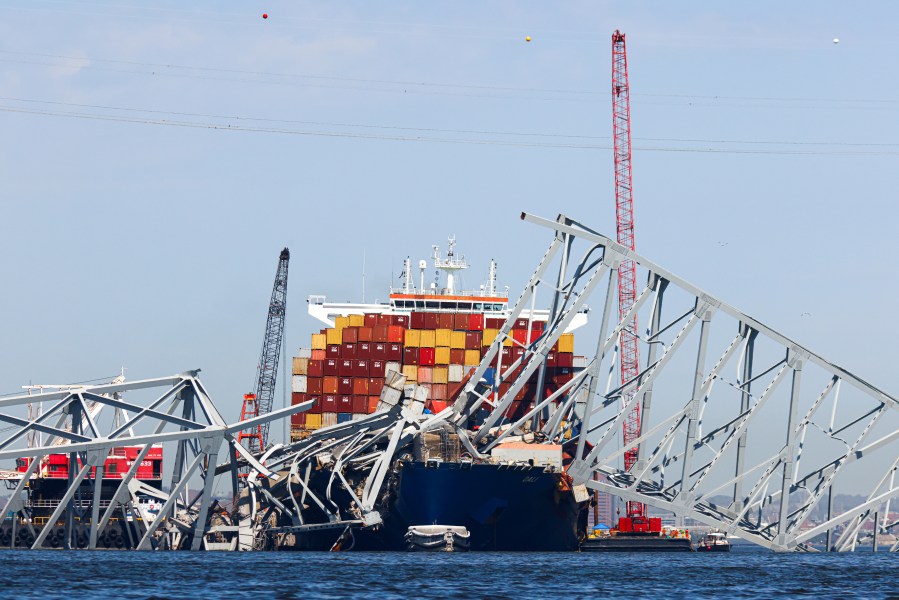 The collapsed Francis Scott Key Bridge lay on top of the container ship Dali, Monday, April 15, 2024, in Baltimore. The FBI confirmed that agents were aboard the Dali conducting court-authorized law enforcement activity. (AP Photo/Julia Nikhinson)